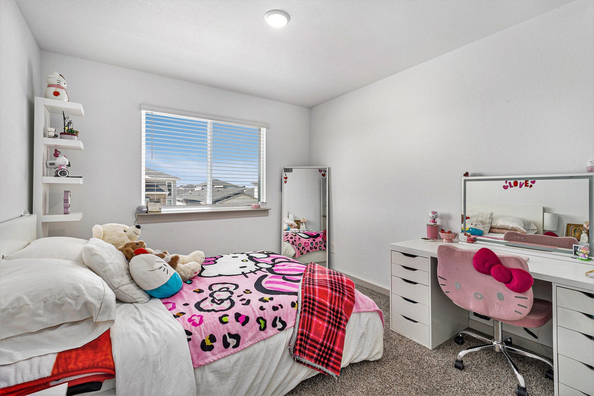 Bright upstairs secondary bedroom offering comfortable living space and a large window for natural light.