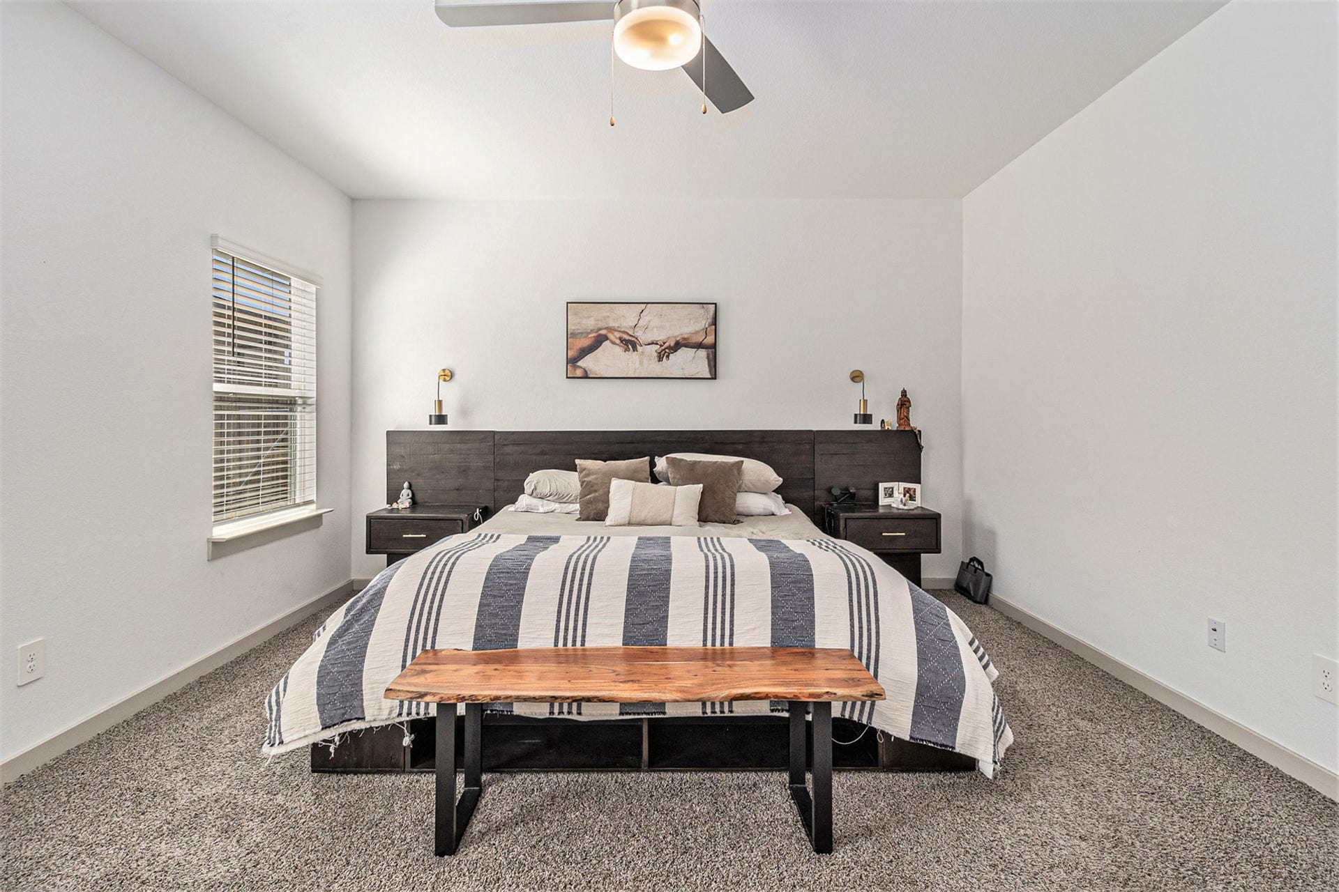 Another view of the generously sized first-floor primary bedroom, offering a comfortable private retreat away from the upstairs secondary bedrooms.