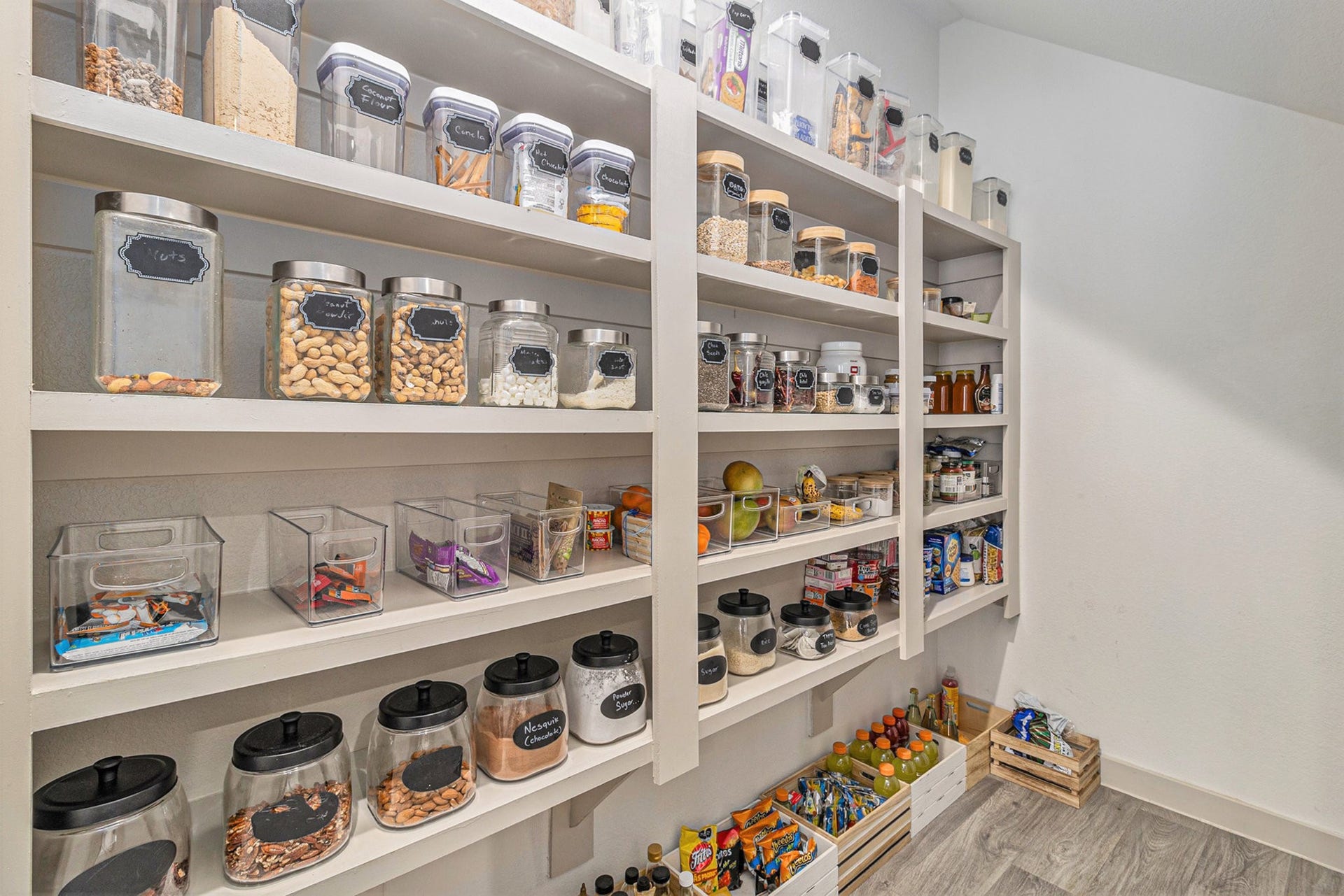 A standout featurethis spacious walk-in pantry offers extensive shelving and exceptional storage for groceries, small appliances, and everyday essentials.