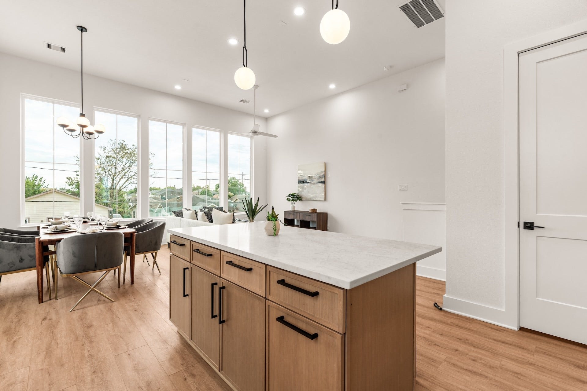 6619 Avenue Q, #B, Houston, TX 77011 Large kitchen island with breakfast bar seating overlooking the light-filled dining and living spaces.