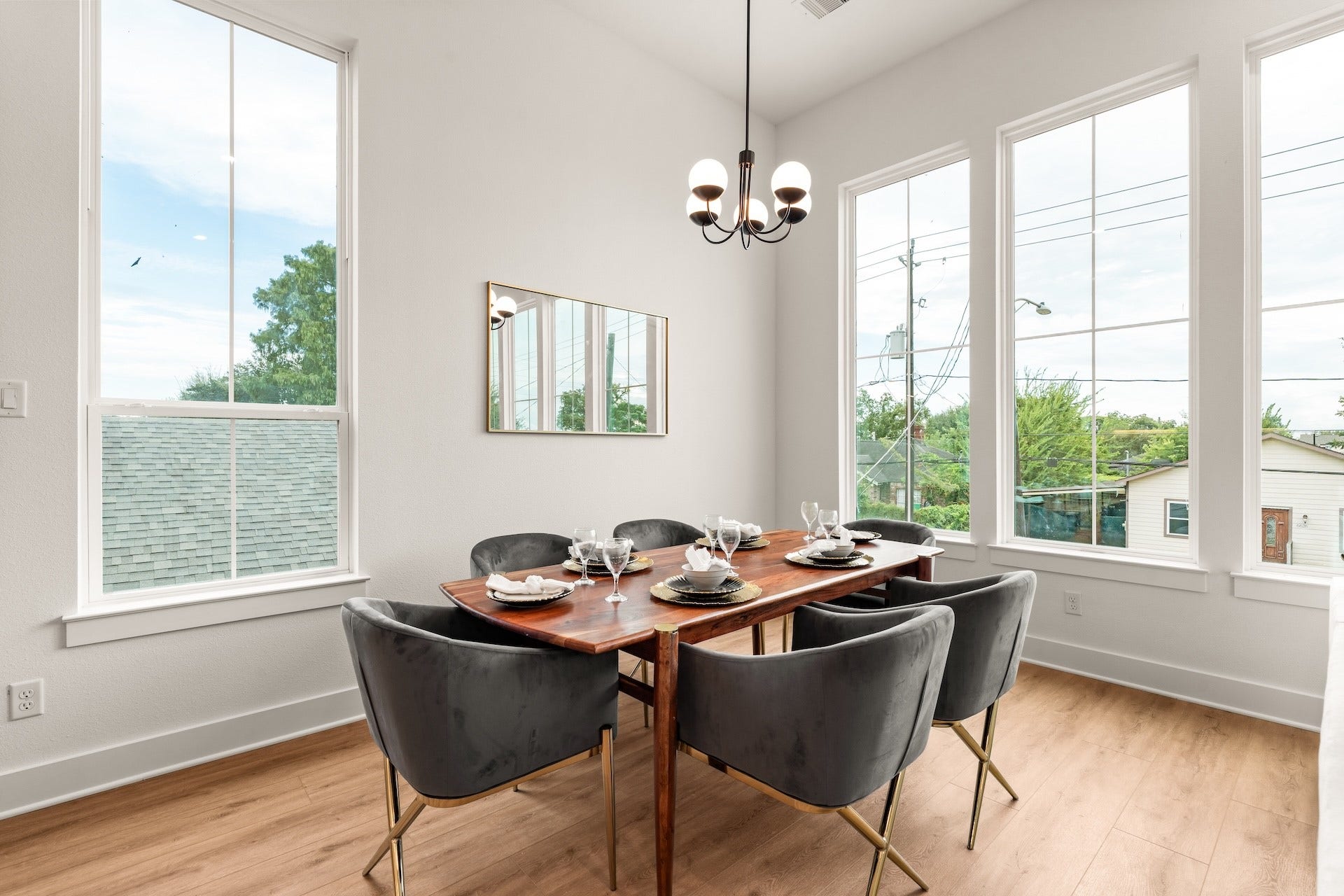 6619 Avenue Q, #B, Houston, TX 77011 Elegant dining room layout highlighted by designer lighting and sweeping tree-lined neighborhood views.