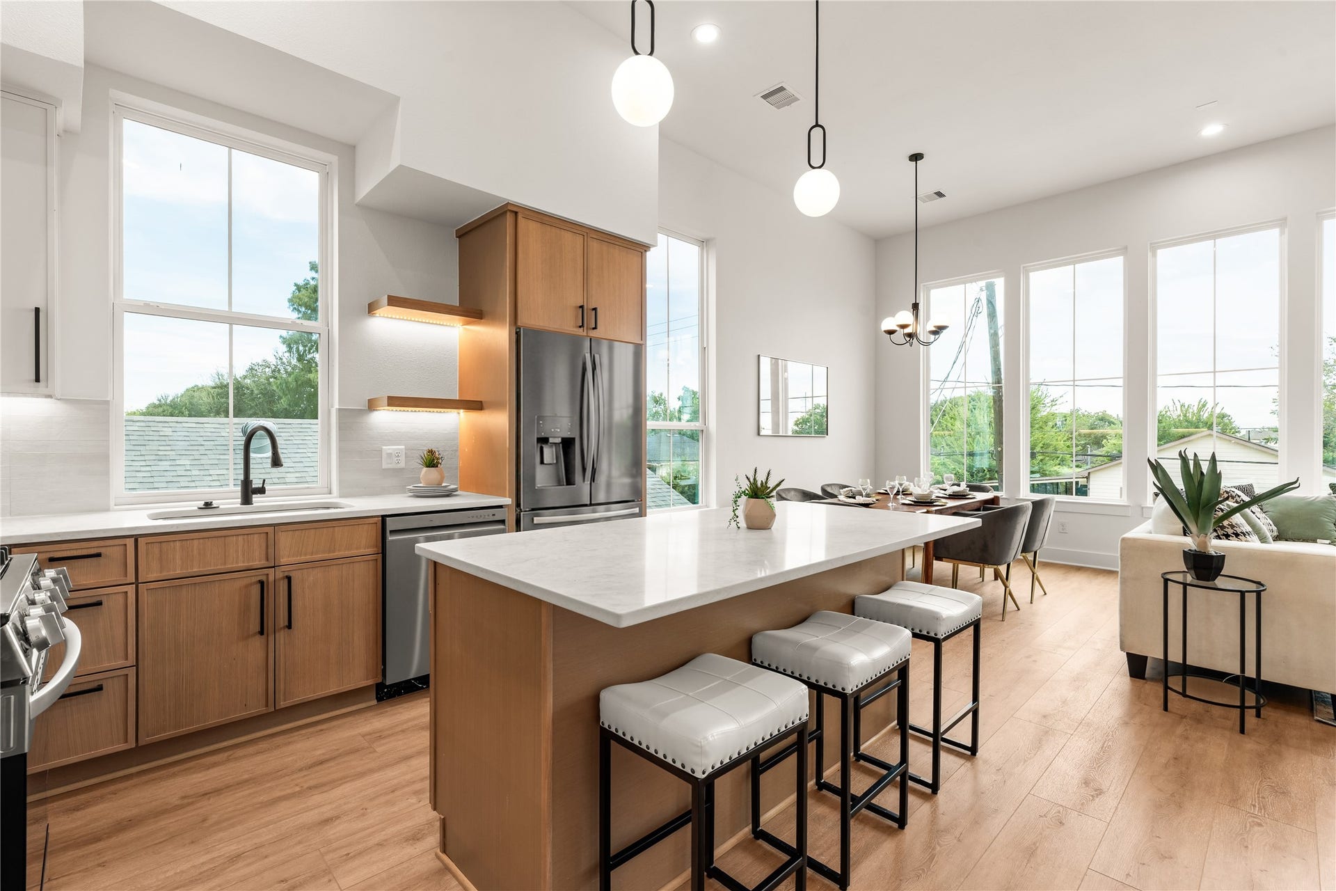 6619 Avenue Q, #B, Houston, TX 77011 Modern kitchen workflow featuring seamless access to the open dining area and main living space.
