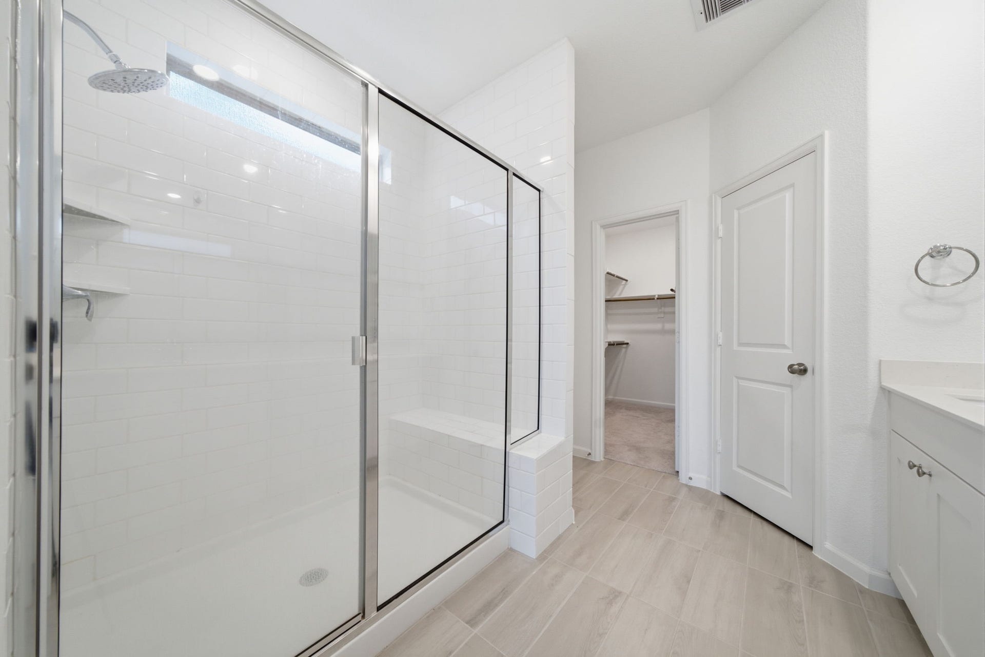 2446 Rosemary Sage Drive, Brookshire, TX 77423 The en-suite primary bath features a spacious walk-in shower, creating a bright and comfortable space for everyday relaxation.
