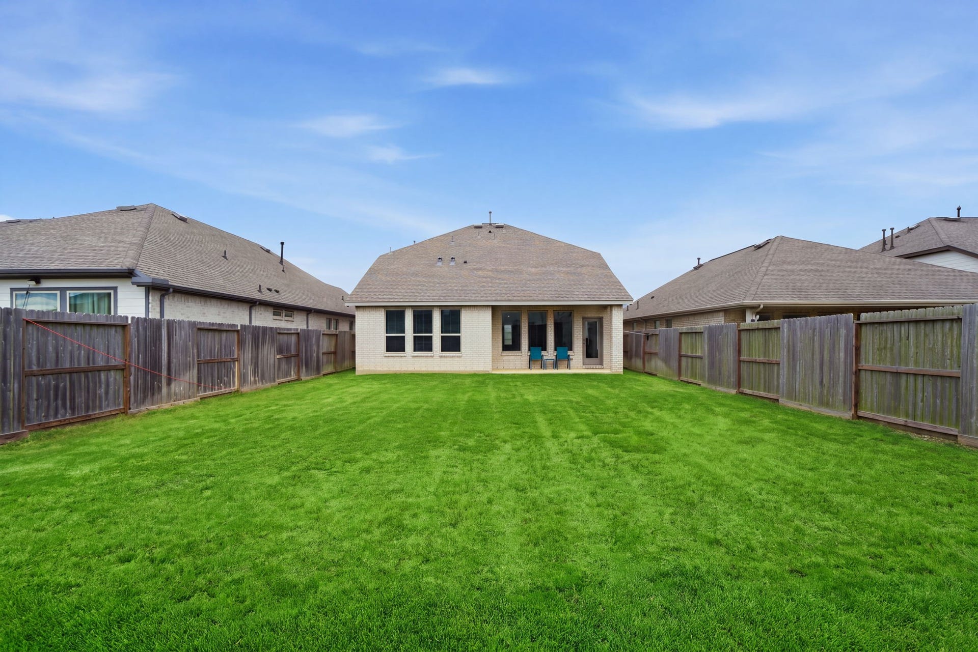 2446 Rosemary Sage Drive, Brookshire, TX 77423 Another view of the spacious backyard, showcasing a versatile outdoor area with plenty of room for relaxing, dining, and entertaining.