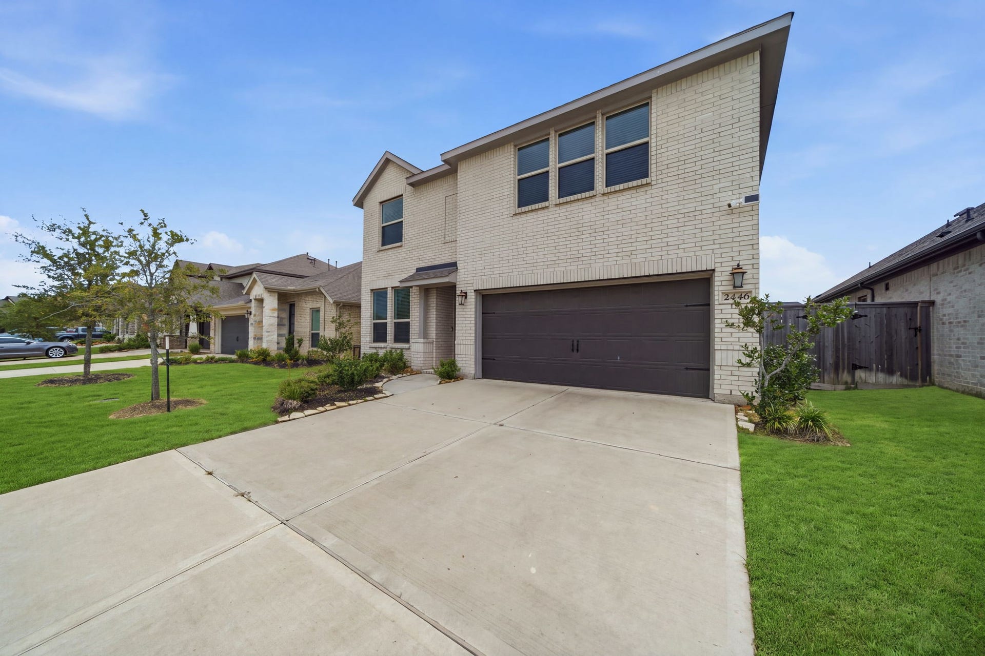 2446 Rosemary Sage Drive, Brookshire, TX 77423 Ample parking with a spacious two-car garage, offering convenient parking and additional storage space.