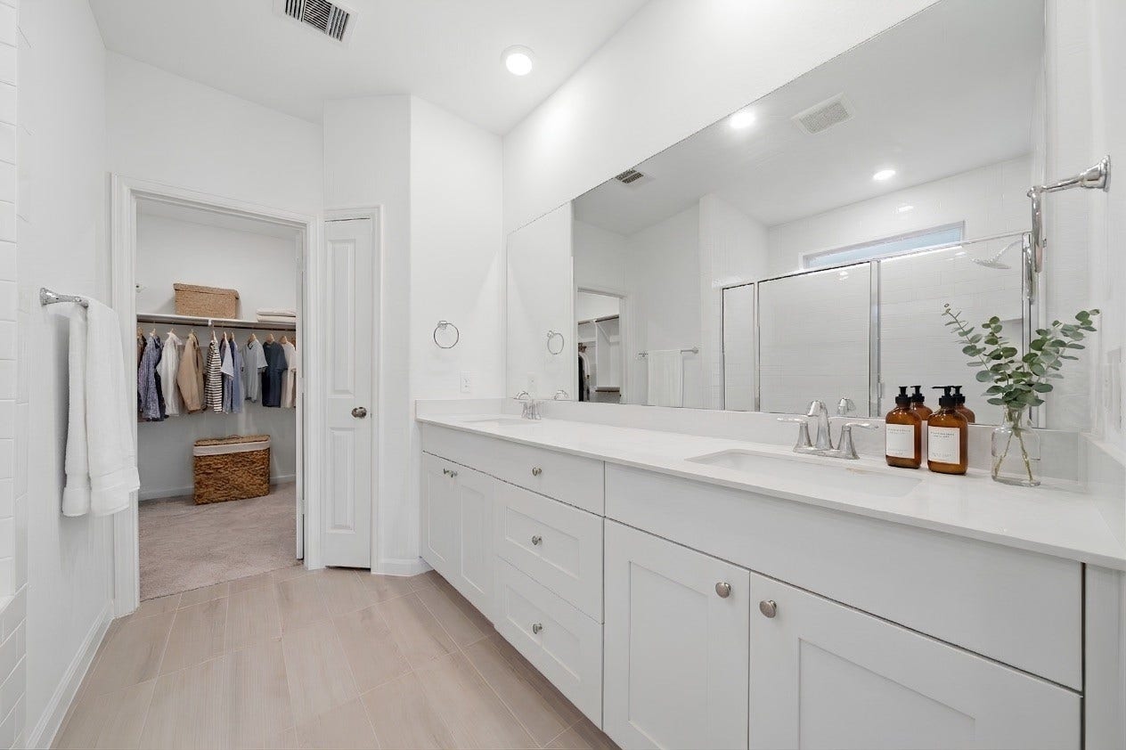 2446 Rosemary Sage Drive, Brookshire, TX 77423 The en suite primary bath features an expansive vanity with dual sinks and plenty of cabinet storage, offering both style and functionality.