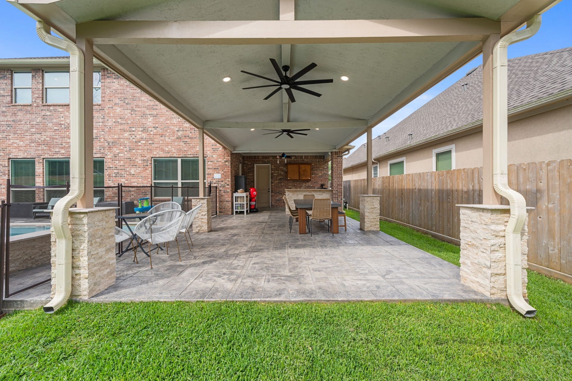 Covered outdoor living space with outdoor kitchen designed for year-round enjoyment
