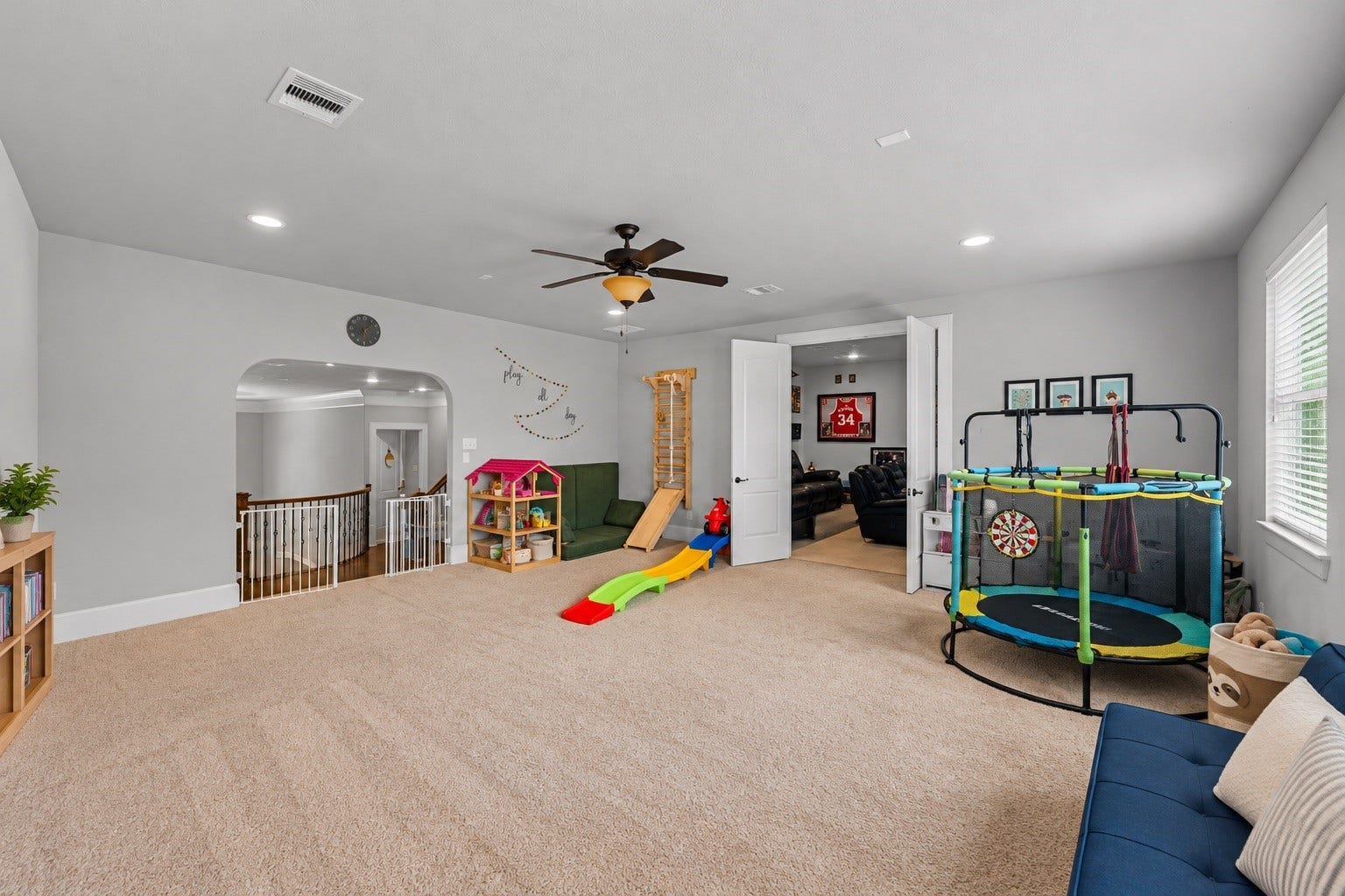 Upstairs game room and media room offering flexible space for entertaining, play, or relaxing