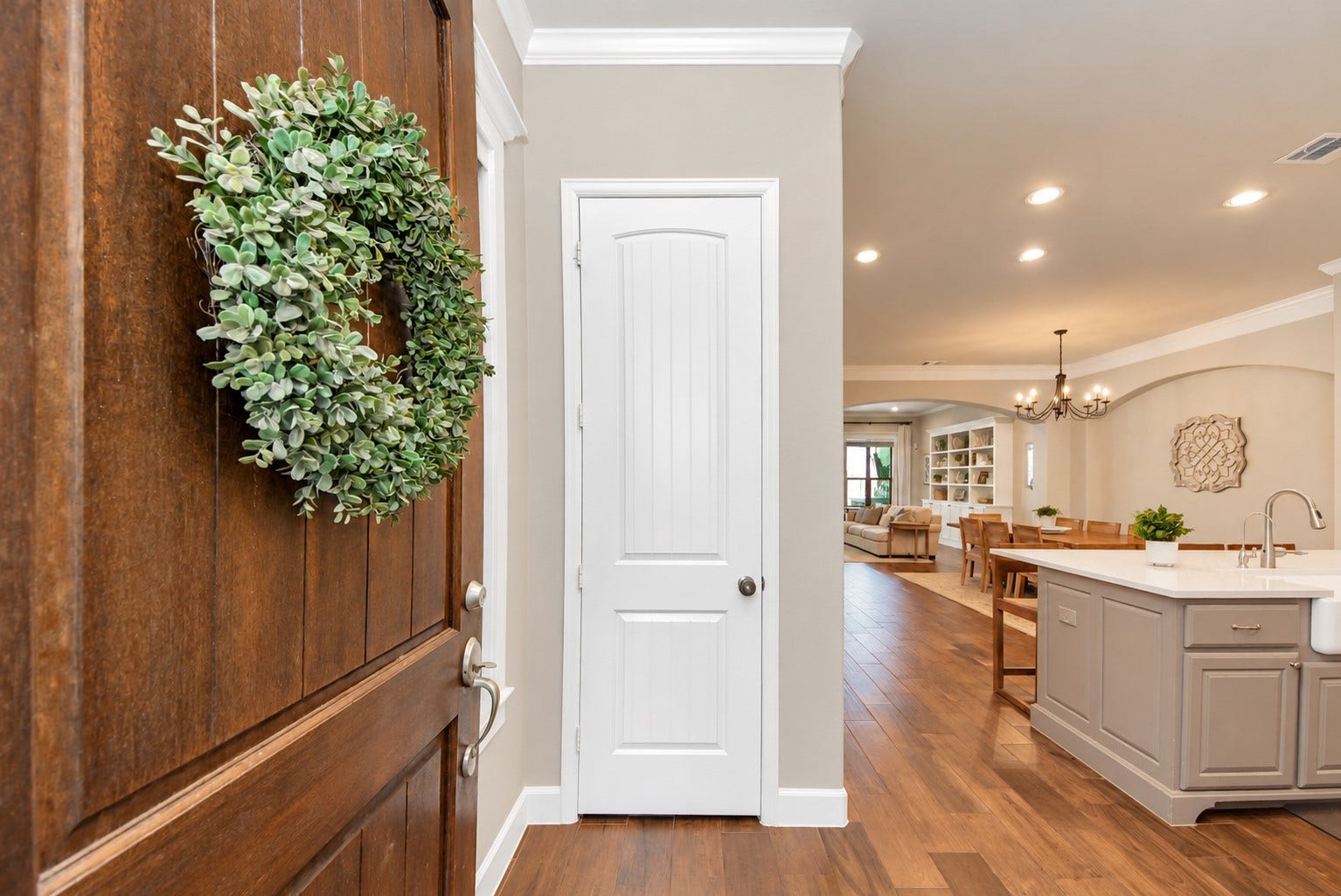 832 W 22nd Street, Houston, TX 77008 Welcoming entryway with rich wood flooring and an open view of the kitchen, dining, and living areas.