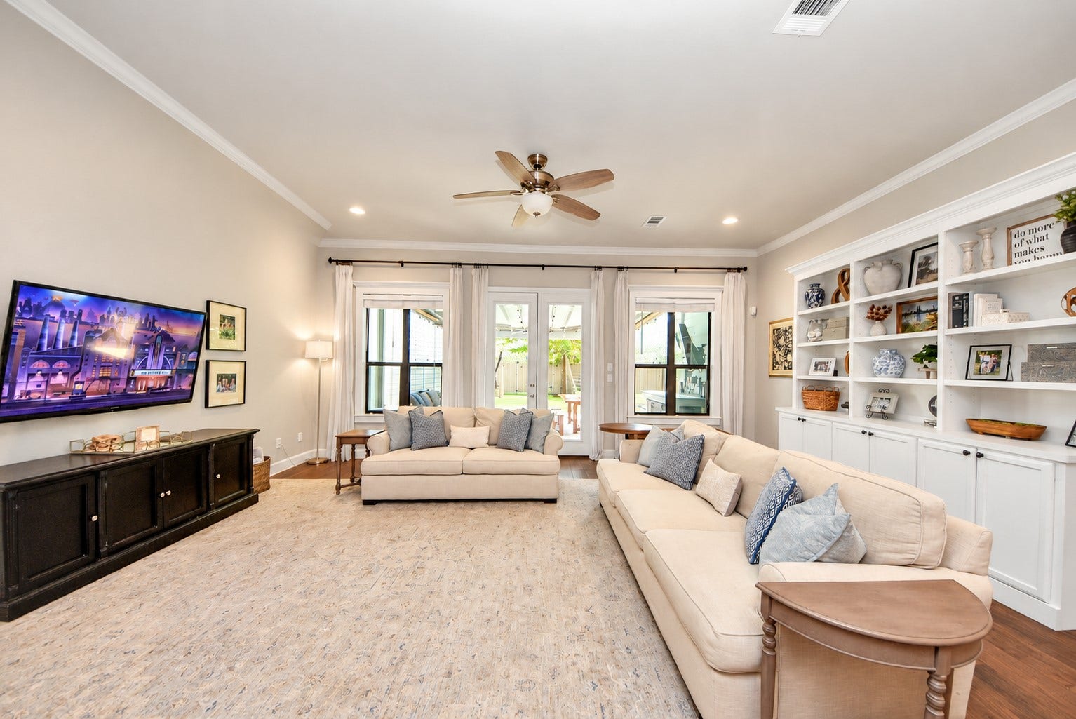 832 W 22nd Street, Houston, TX 77008 Another view of the primary living area showcasing large windows, custom built-in cabinetry, and an inviting atmosphere.