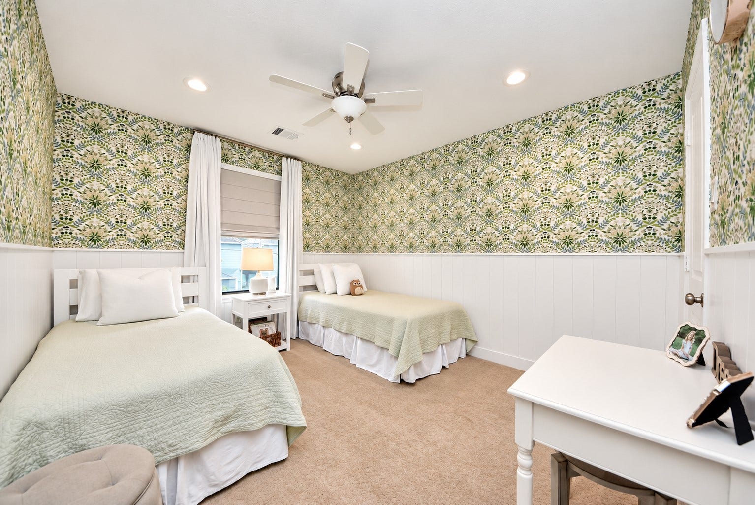 832 W 22nd Street, Houston, TX 77008 Beautifully designed secondary bedroom featuring custom wallpaper, classic white wainscoting, recessed lighting, and a spacious layout with room for multiple beds.