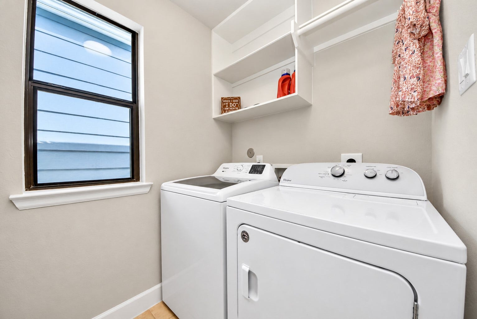 832 W 22nd Street, Houston, TX 77008 Dedicated laundry room with washer and dryer connections, overhead shelving for additional storage, and a window that welcomes natural light.