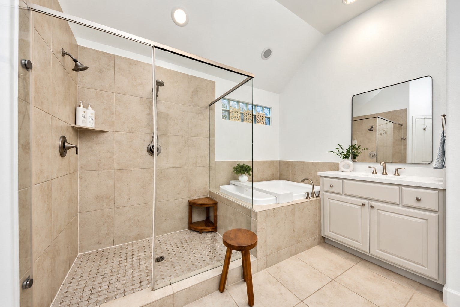 832 W 22nd Street, Houston, TX 77008 Beautiful primary bathroom featuring a glass-enclosed shower, soaking tub, and generous vanity storage.