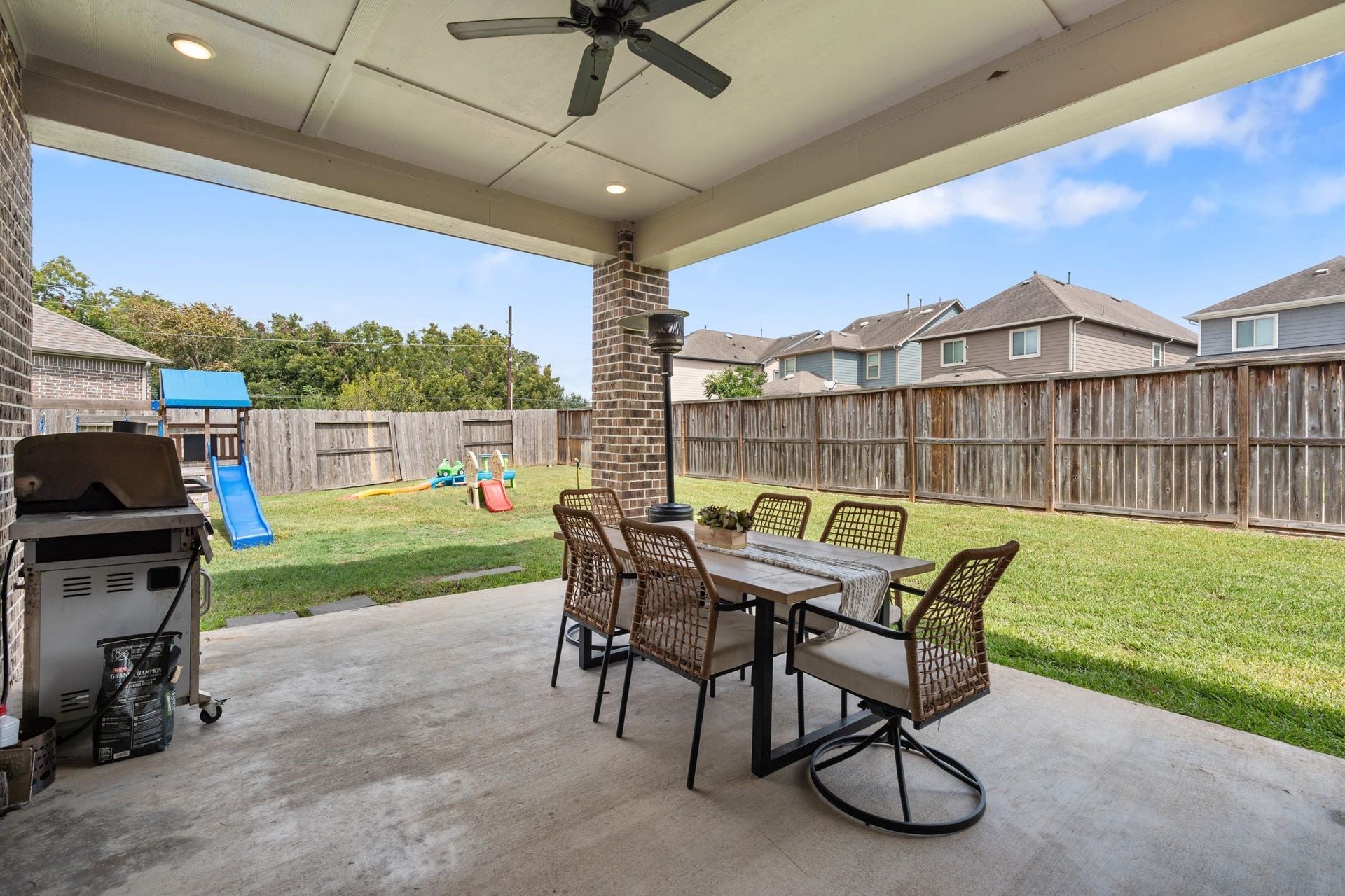 Large covered patio with a ceiling fan and canned lights overlooking your big backyard.
