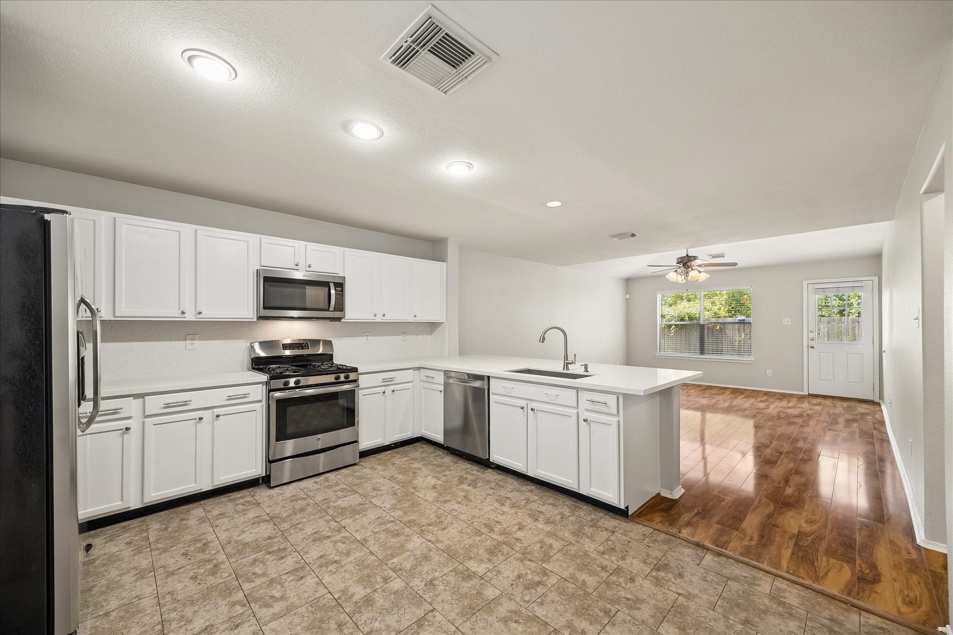 223 Sunset Colony Drive, Rosharon, TX 77583 This kitchen keeps everything within easy reach, with plenty of counter space, stainless-steel appliances, crisp white cabinetry and an open connection to both casual and formal areas that makes everyday life and entertaining feel effortless.