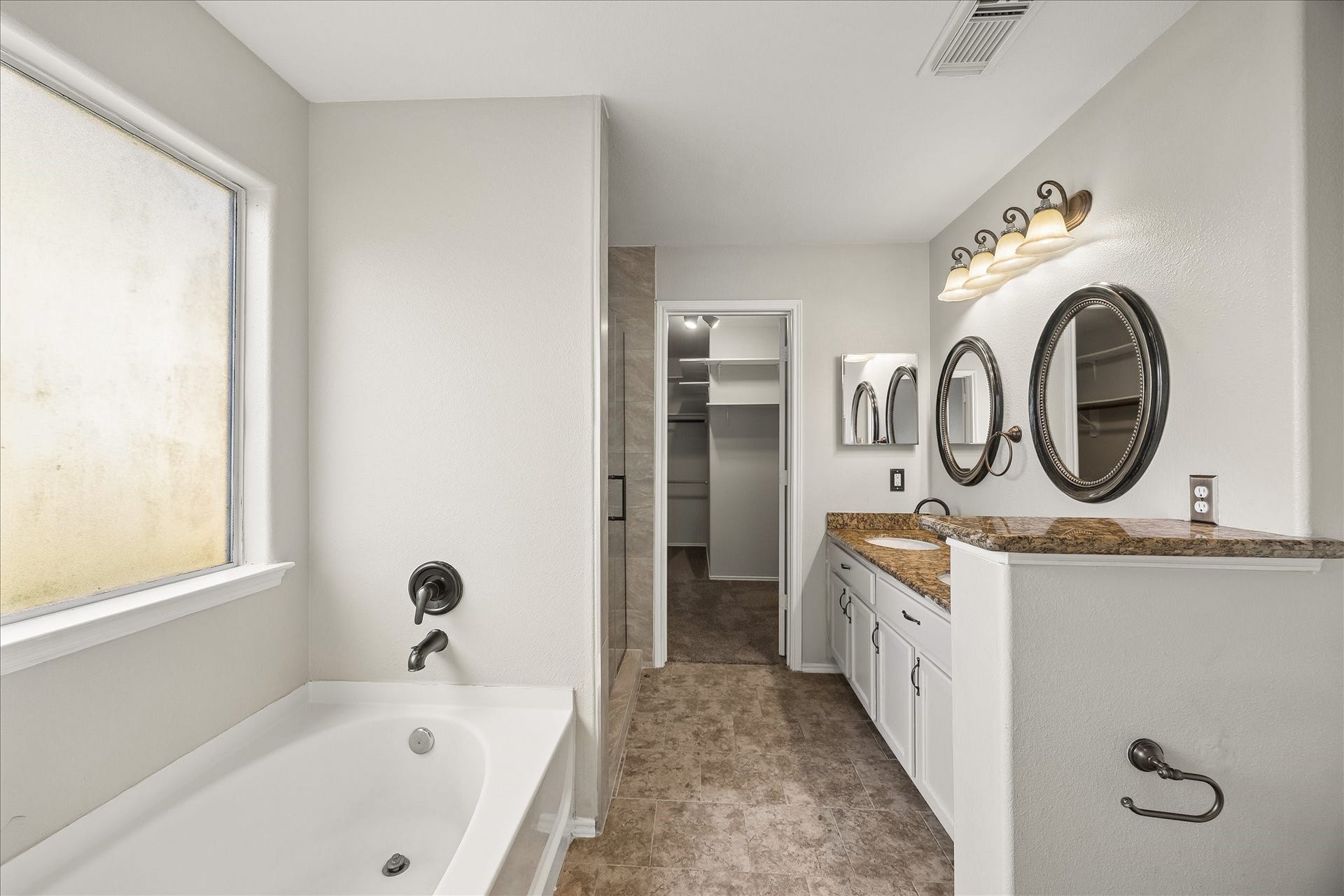 223 Sunset Colony Drive, Rosharon, TX 77583 Enjoy a daily dose of luxury in this private ensuite with a deep soaking tub, separate walk-in shower, dual sink vanity and massive walk-in closet.