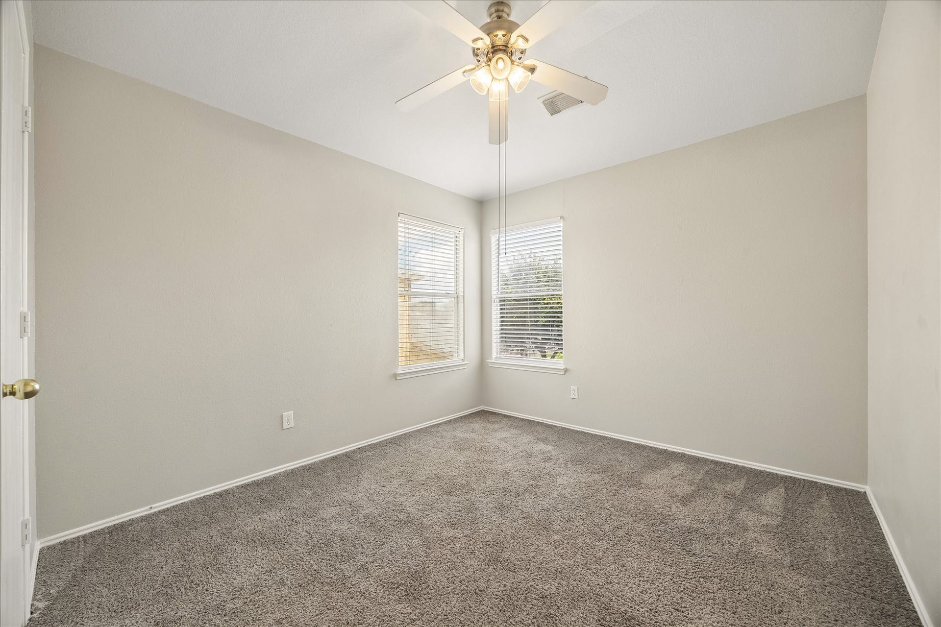 223 Sunset Colony Drive, Rosharon, TX 77583 Rounding out the bedrooms upstairs, this spacious guest room keeps things fresh and comfortable with soft neutral finishes, plush carpet, a cooling ceiling fan and natural light from corner windows.