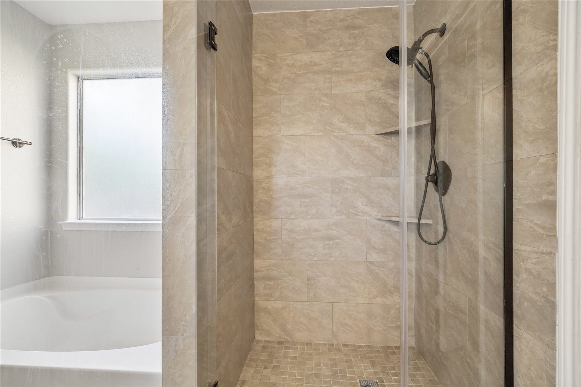 223 Sunset Colony Drive, Rosharon, TX 77583 The walk-in shower adds another layer of comfort to the primary ensuite, offering a sleek space to refresh and recharge at the start or end of the day.