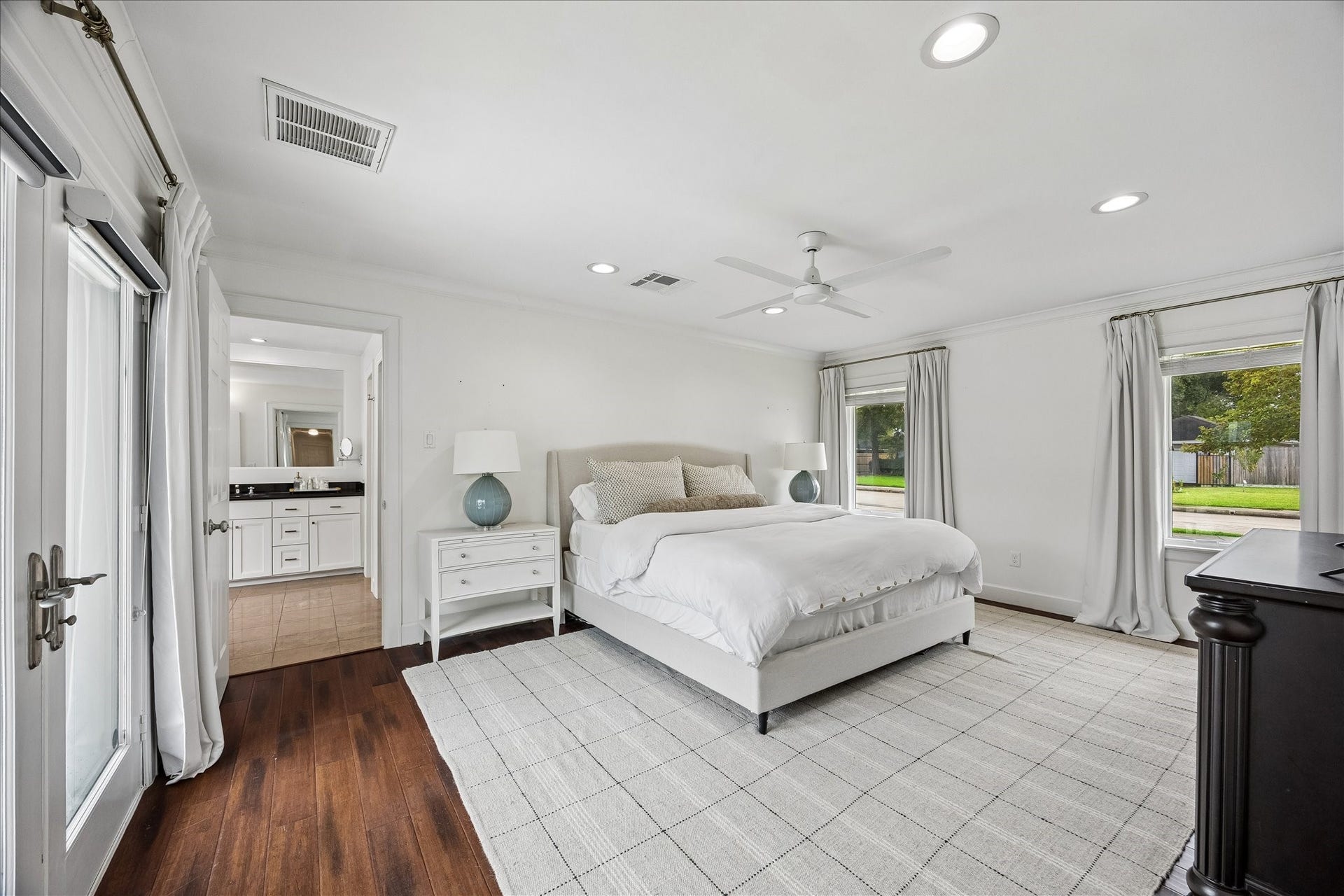 3702 Linkwood Drive, Houston, TX 77025 The large primary suite offers natural light with windows and French doors leading to the outdoor oasis.