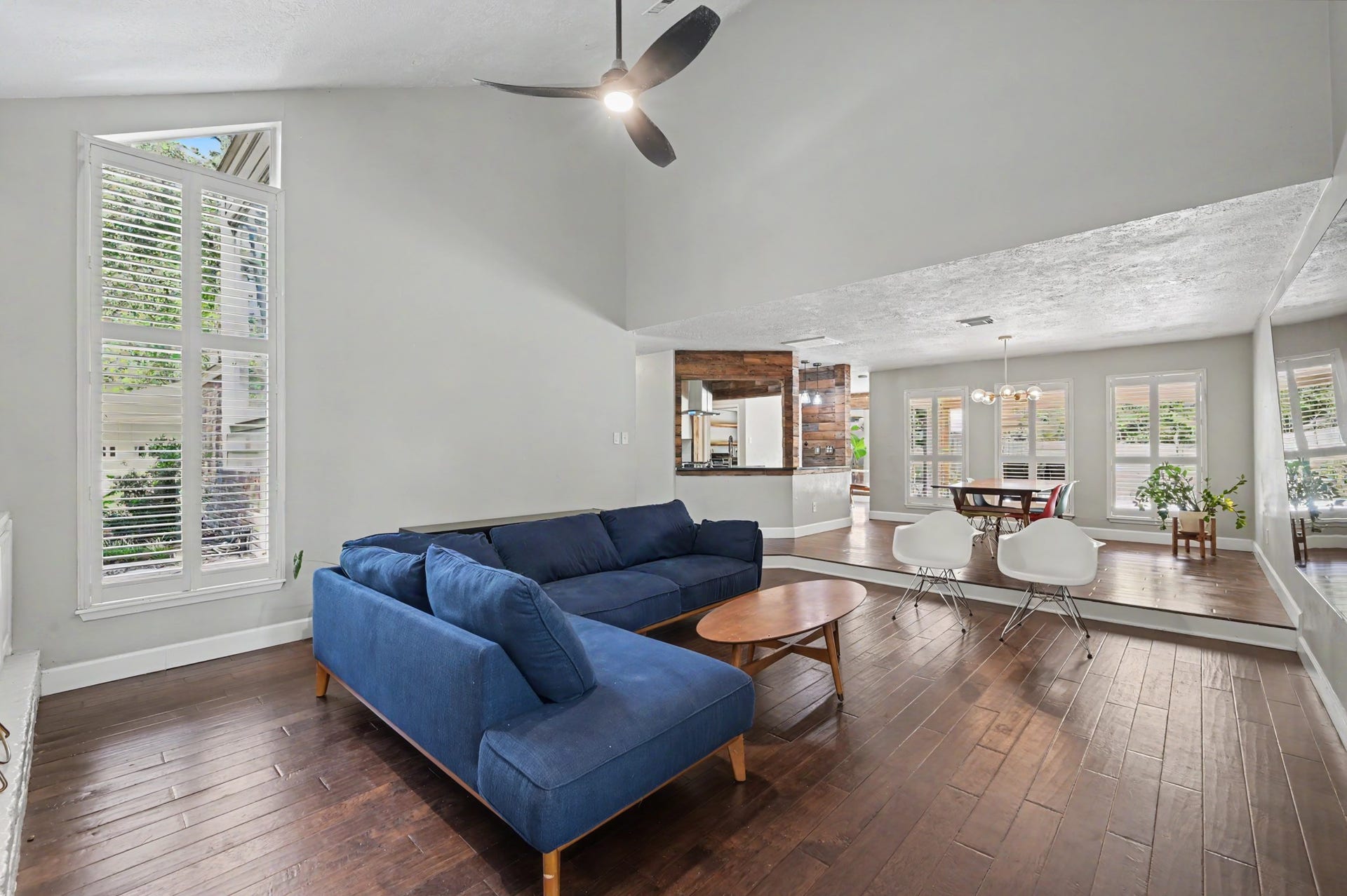 2314 Chestnut Oak Place, The Woodlands, TX 77380 The living room opens naturally toward the dining area and kitchen, with tall plantation-shuttered windows bringing in plenty of natural light.