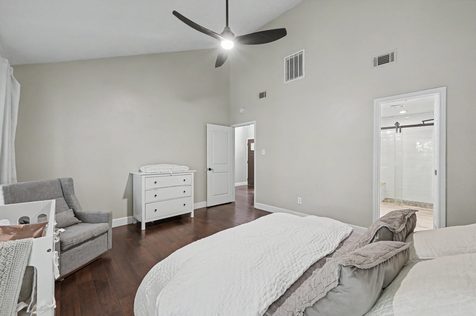 2314 Chestnut Oak Place, The Woodlands, TX 77380 Another view of the primary suite highlights its vaulted ceiling, updated ceiling fan, and seamless flow with the rest of the home.