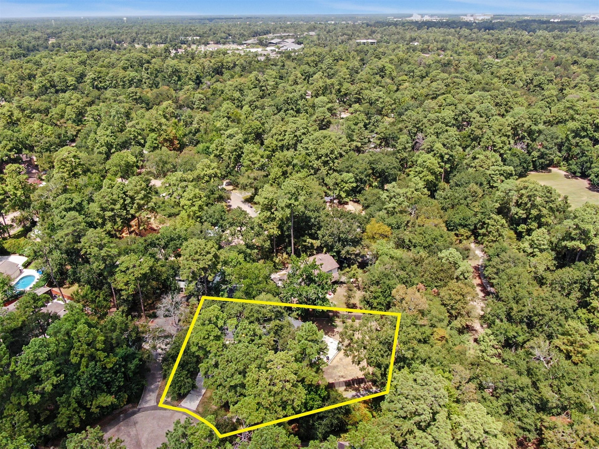 2314 Chestnut Oak Place, The Woodlands, TX 77380 Wide aerial view showcases the homes private cul-de-sac setting, mature tree canopy that Grogan's Mill is known for, and the home's walkable access to Hailey Elementary, Wilkerson Intermediate and Knox Junior High.