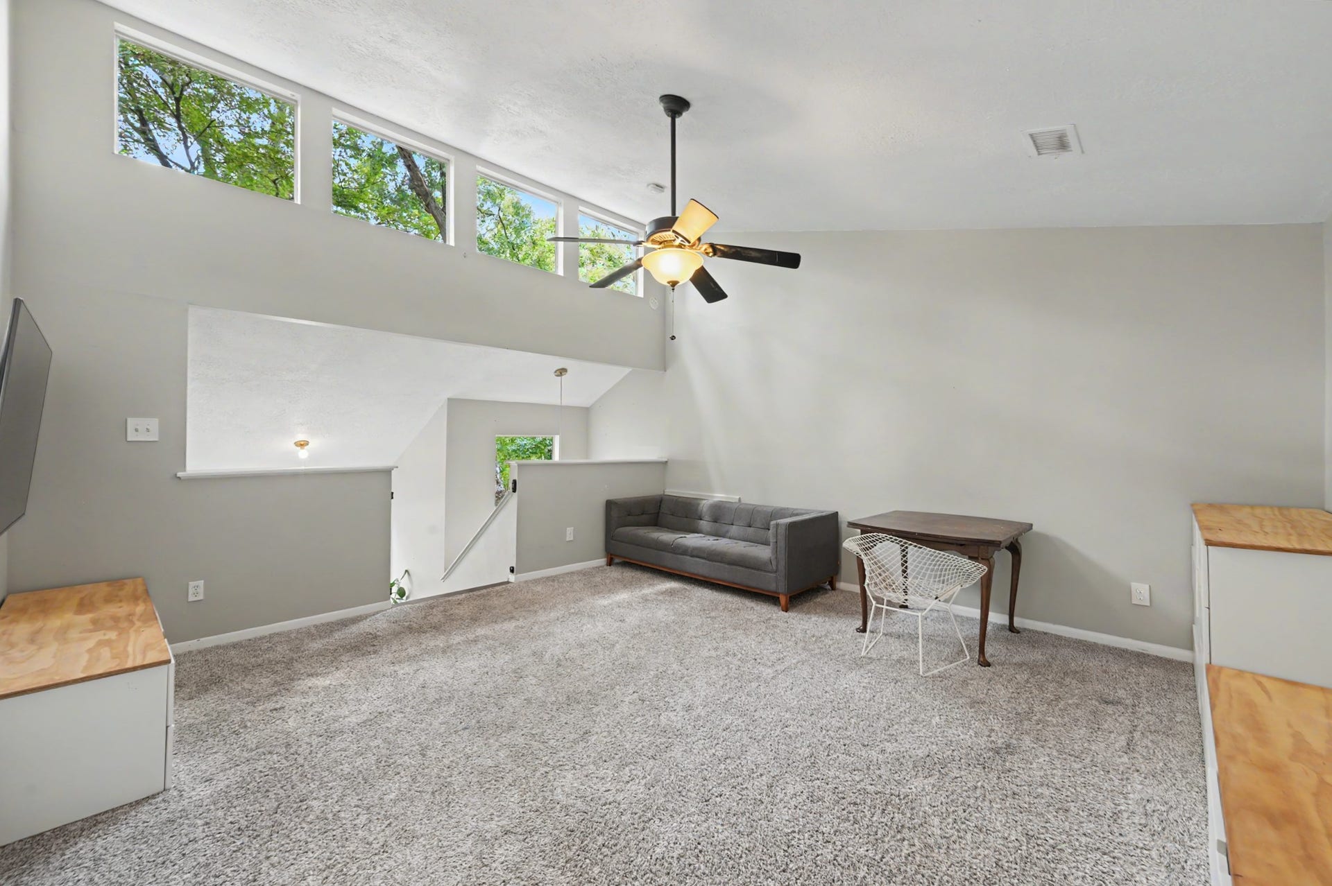 2314 Chestnut Oak Place, The Woodlands, TX 77380 High windows bring natural light and wooded views into the generously sized upstairs game room, a versatile space that can adapt to a variety of needs.