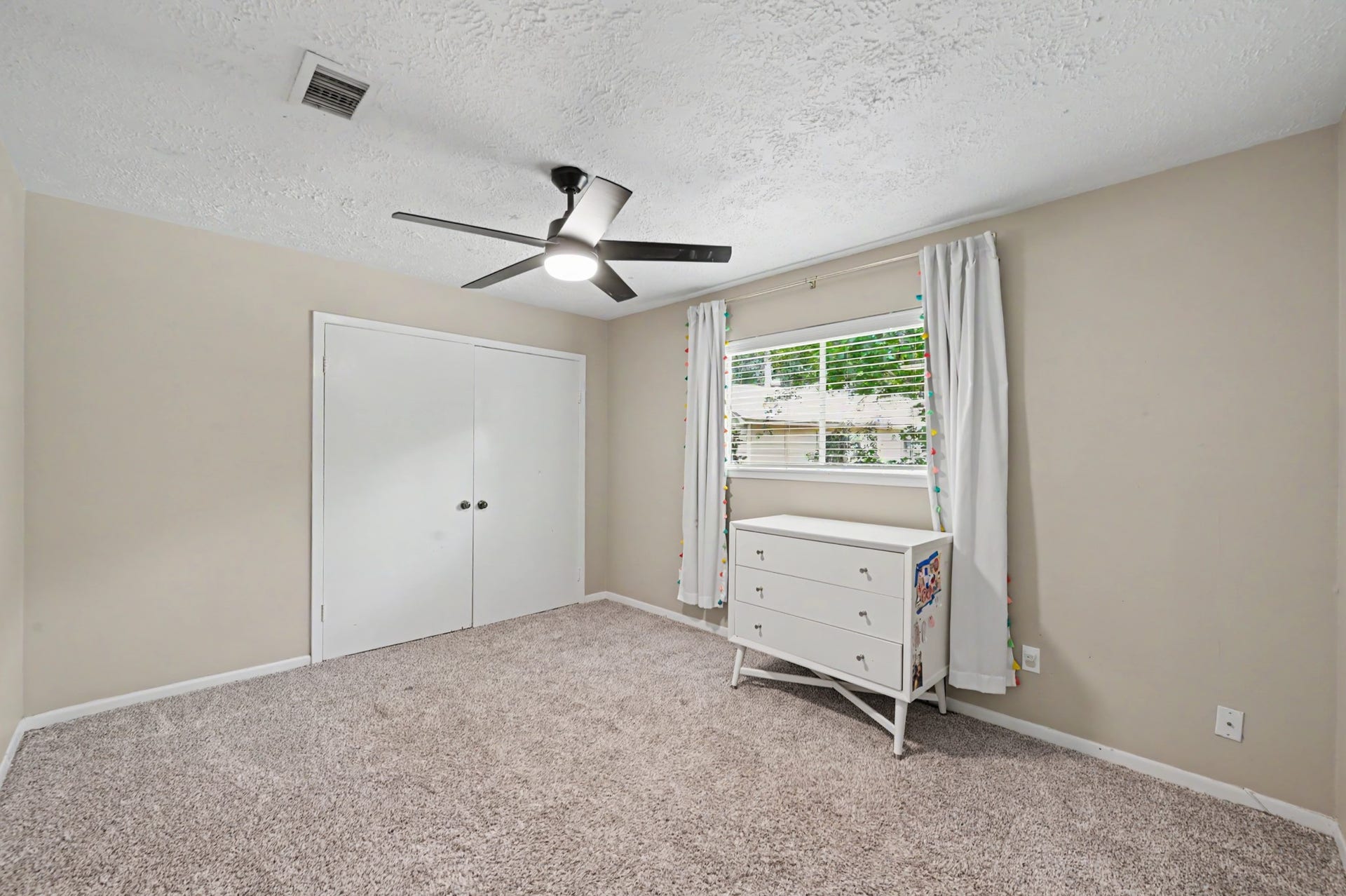 2314 Chestnut Oak Place, The Woodlands, TX 77380 Bedroom #3 is well-sized and features neutral finishes, ample closet storage and views of the surrounding trees.