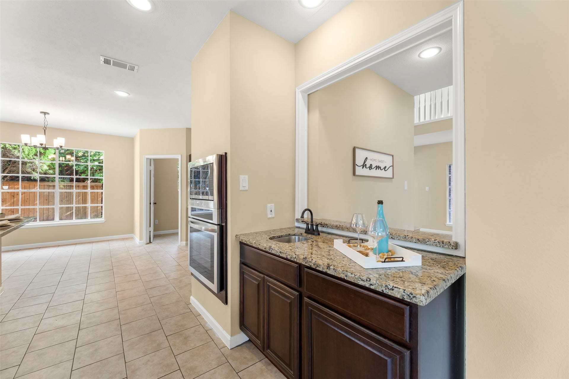 Stainless steel built-in oven and a stylish wet bar with granite countertops, perfect for entertaining.