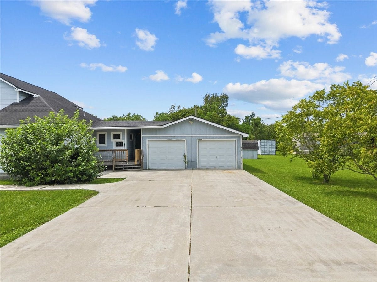 7228 Avenue R, Santa Fe, TX 77510 2 car garage attached with a breezeway to the backyard.