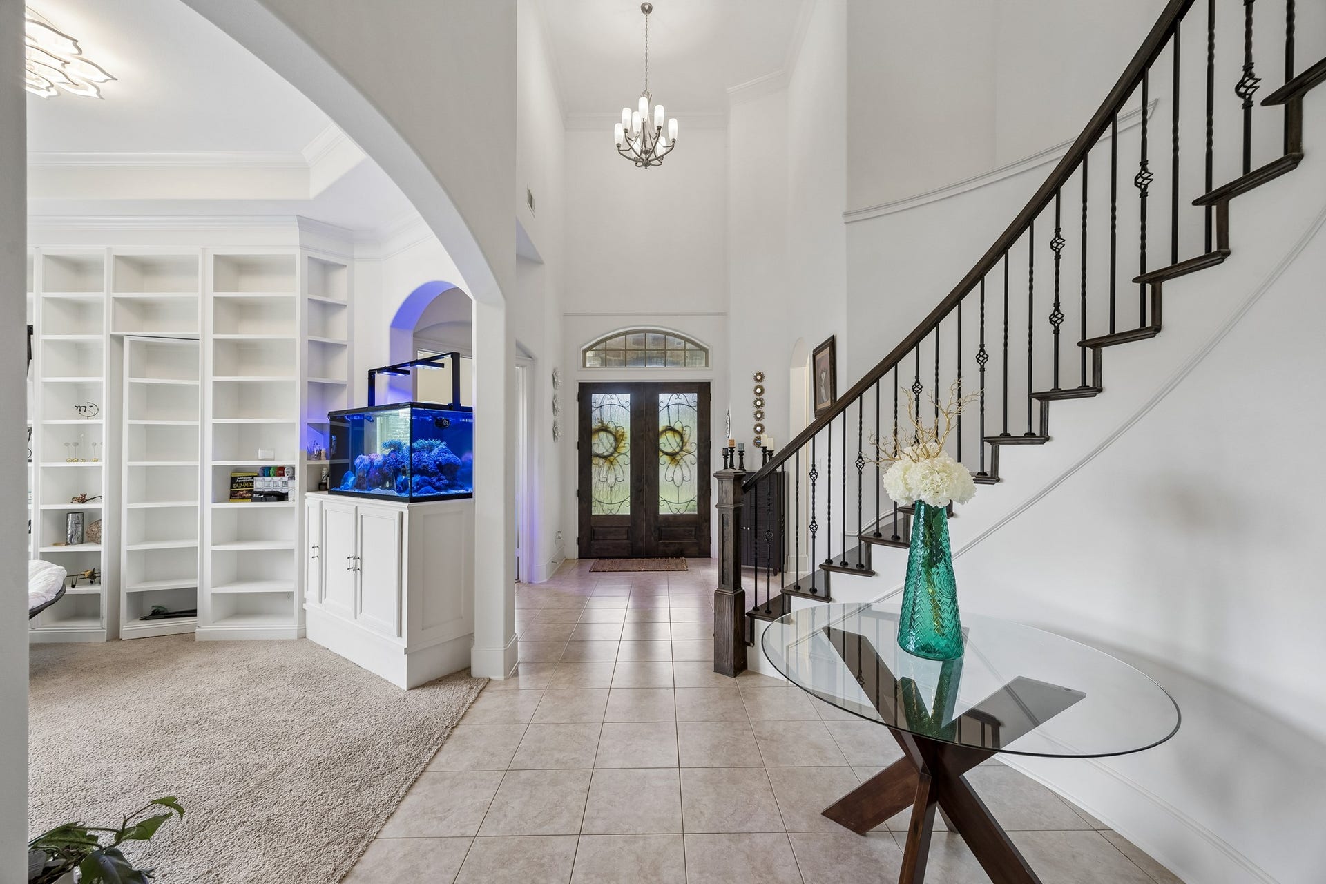 5018 Southampton Road, Missouri City, TX 77459 The elegant entryway features a sweeping staircase, high ceilings and beautiful tile flooring.