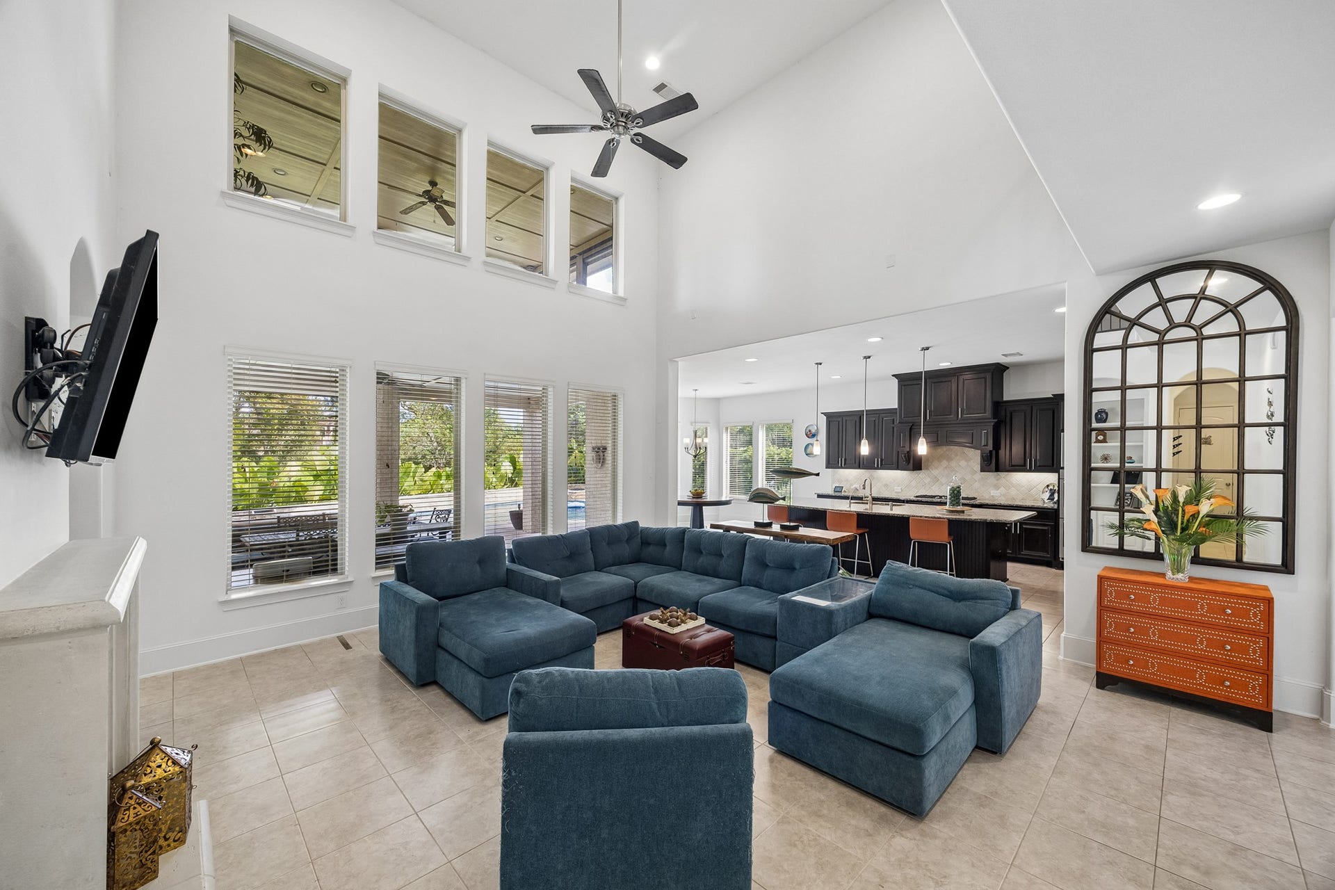 5018 Southampton Road, Missouri City, TX 77459 Spacious living area with high ceilings and large windows that provide amazing views of the backyard pool area and outdoor kitchen area and patio.