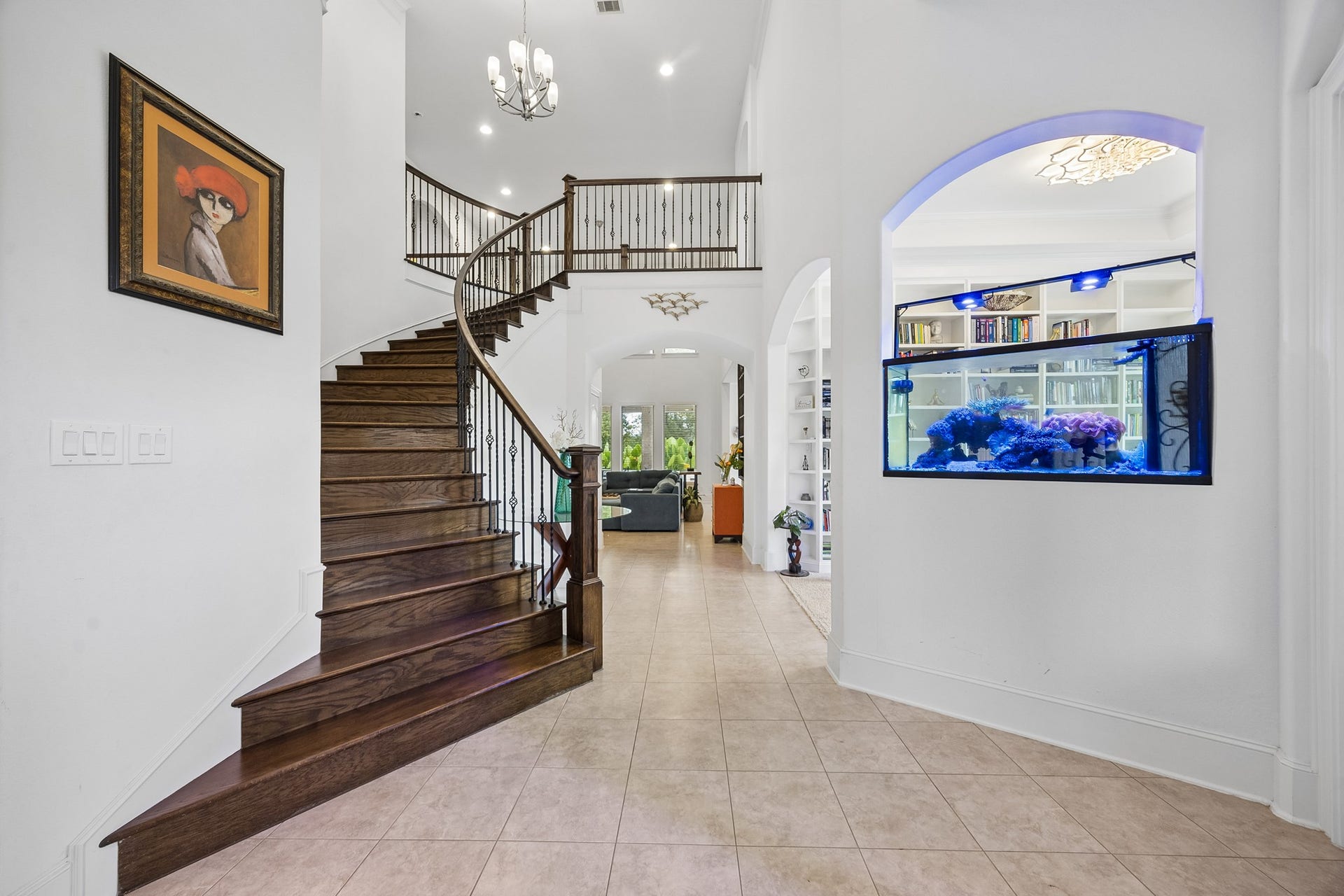 5018 Southampton Road, Missouri City, TX 77459 Elegant foyer with a grand curved staircase leads to a spacious, light-filled living area.