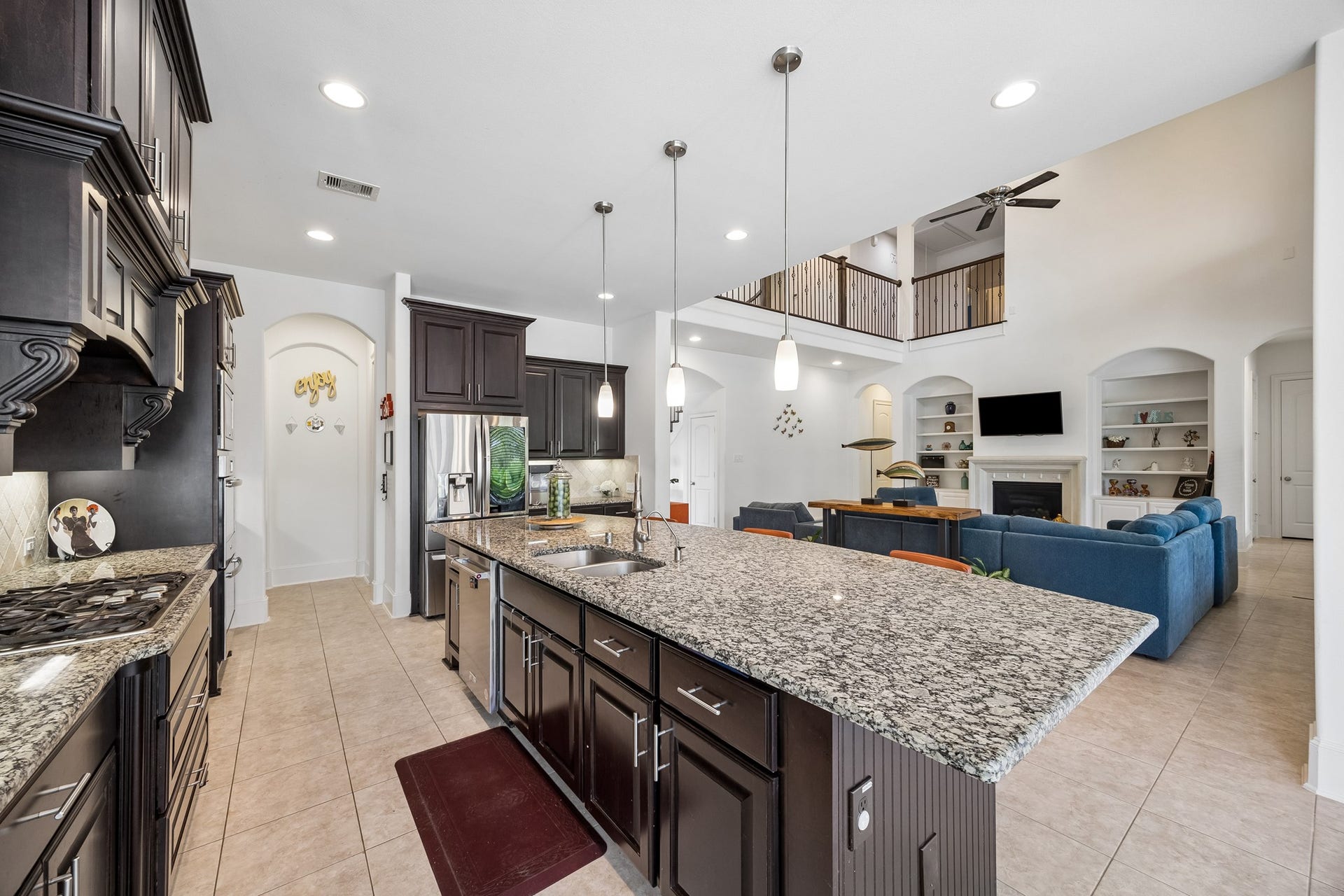 5018 Southampton Road, Missouri City, TX 77459 Experience luxury in this open-concept kitchen featuring a large granite island, stainless steel appliances, and two walk in pantries.