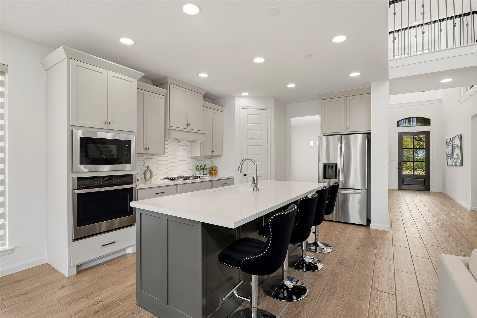 10606 Novy Grove Drive, Missouri City, TX 77459 The 42 inch shaker cabinets are painted in neutral "Accessible Beige" and the island is "Urbane Bronze." The modern backsplash is fabulous!