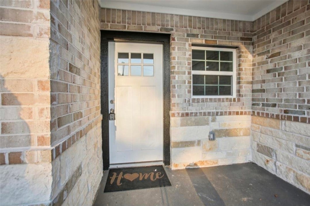 105 Lee Drive, La Marque, TX 77568 Multi panel front door with brick surround front porch