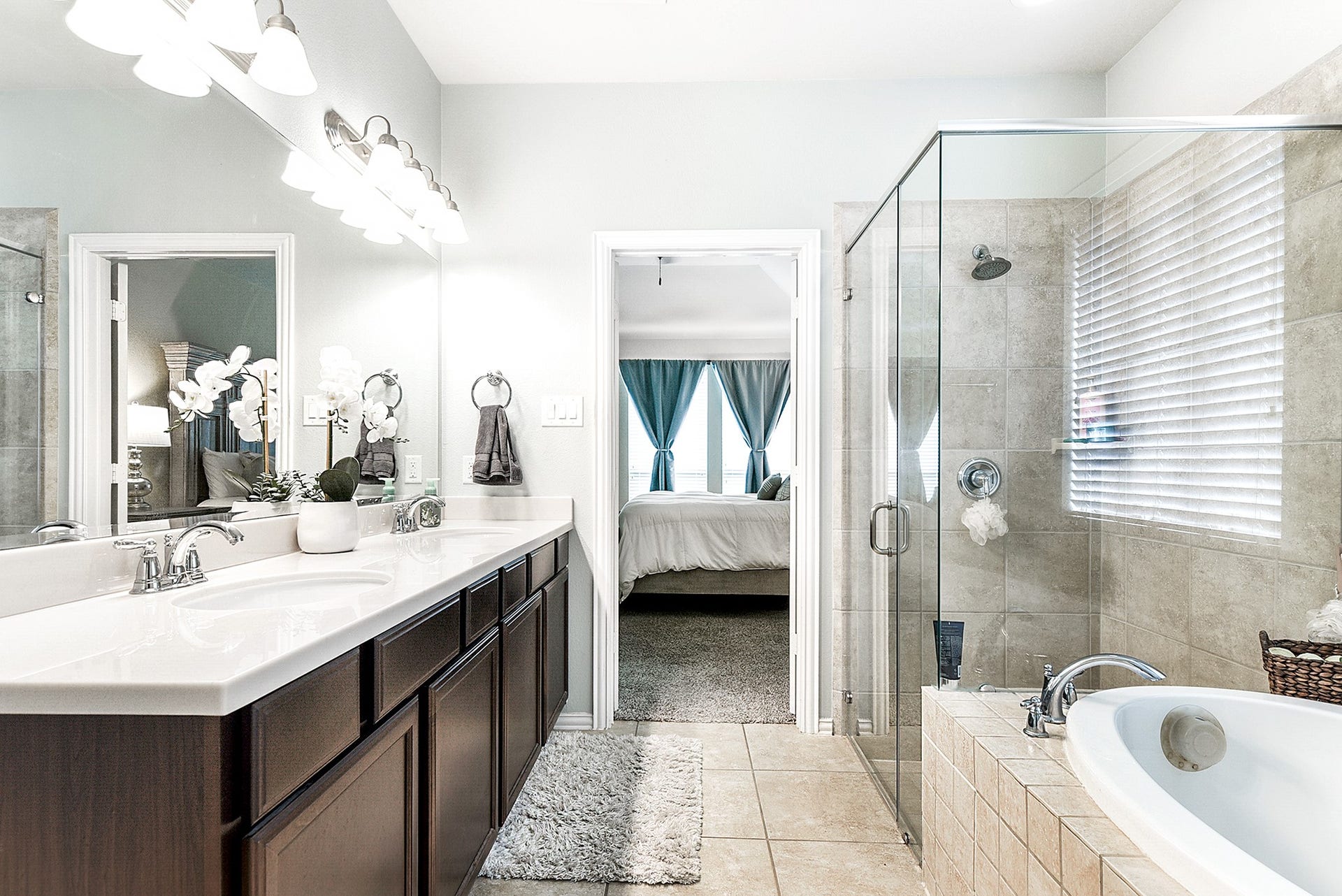 Another view of this ensuite bathroom showcases its elegant design and spacious layout, offering a serene and inviting atmosphere for unwinding and pampering.