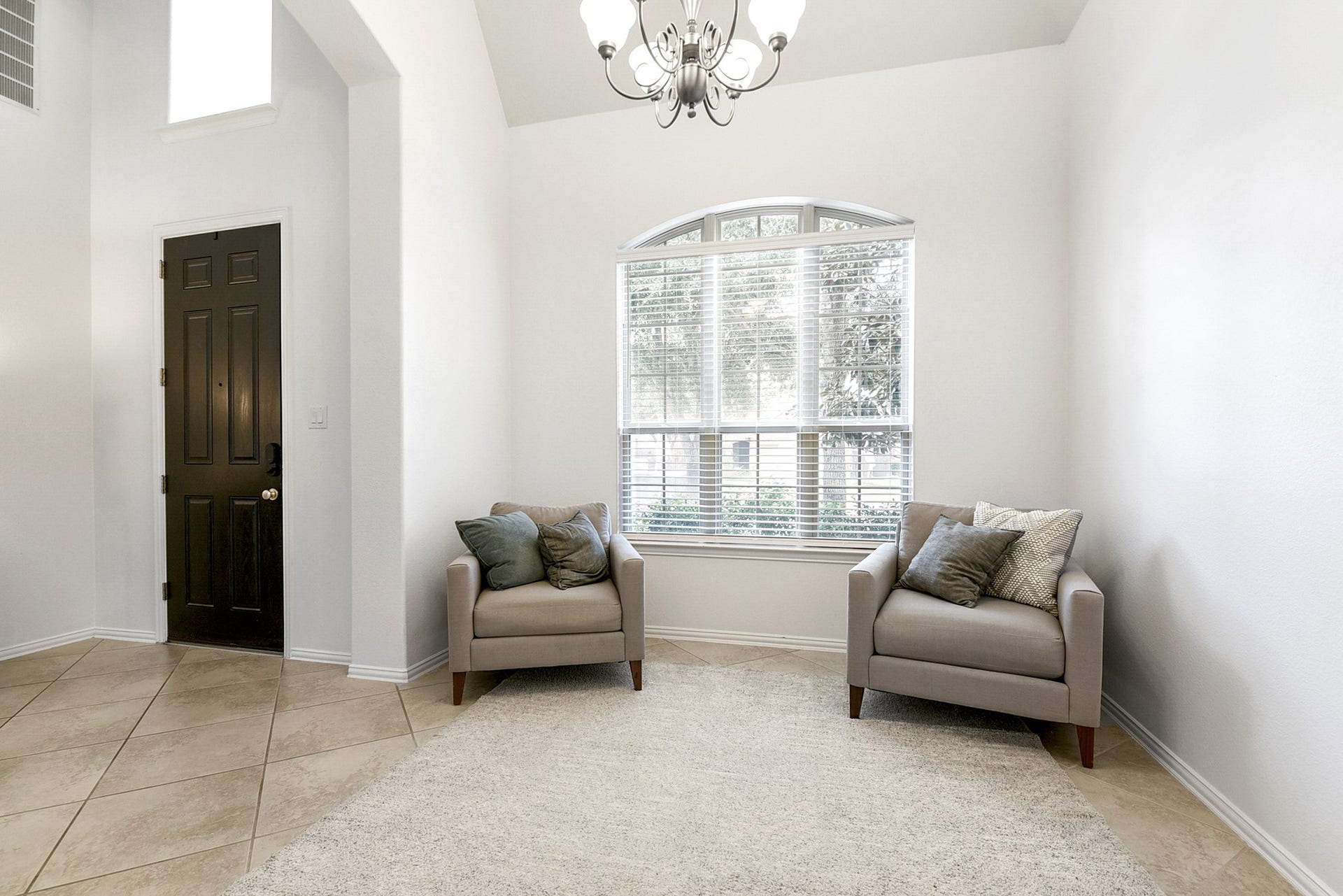 Another view of this formal dinning room, den or additional seating area, perfect for a home office on the main floor. The photo currently shows it being used as a sitting area. Offer same tile throught out the home.