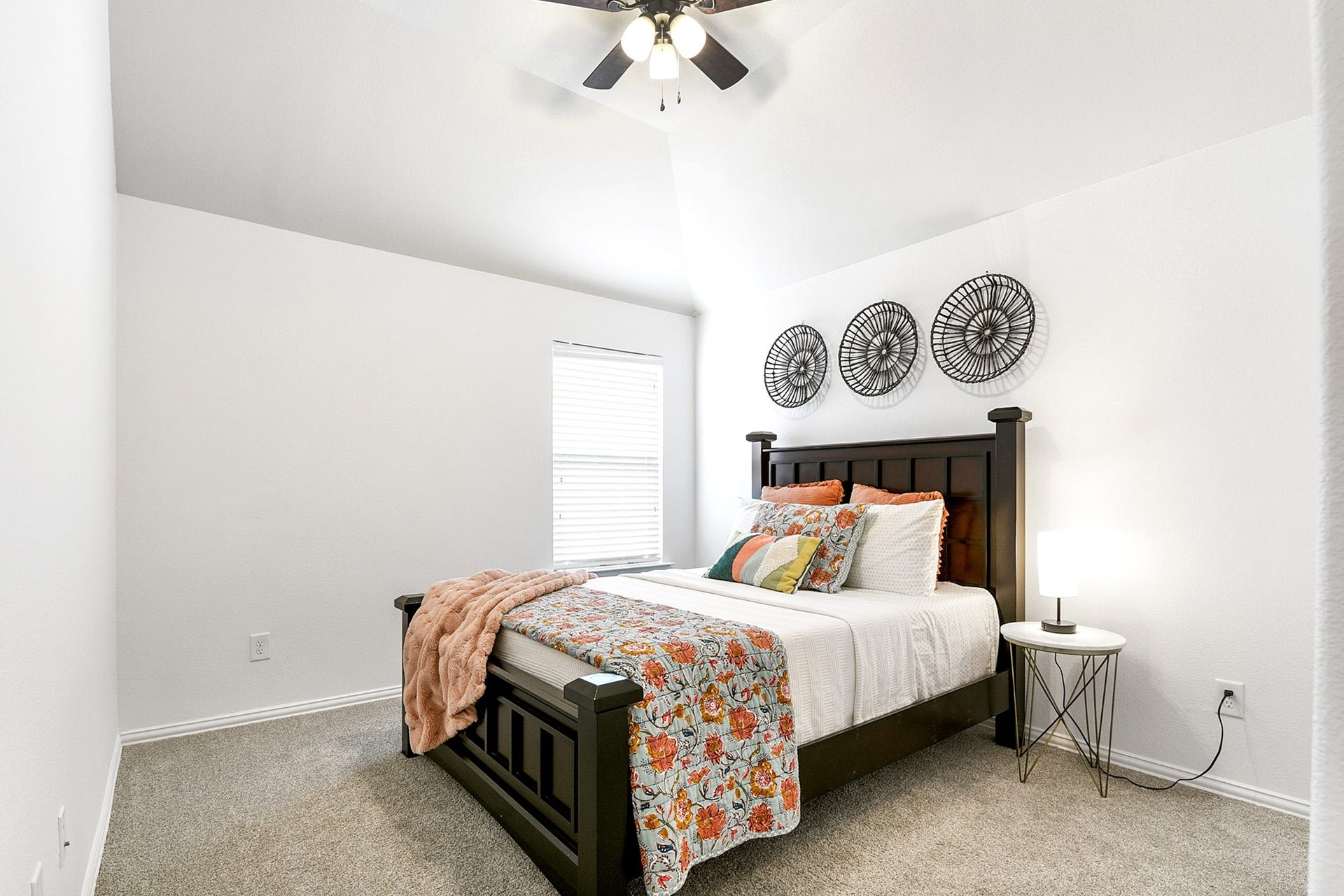 Another upstairs bedroom comes complete with a ceiling fan, providing comfort and airflow, while maintaining the rooms cozy atmosphere.
