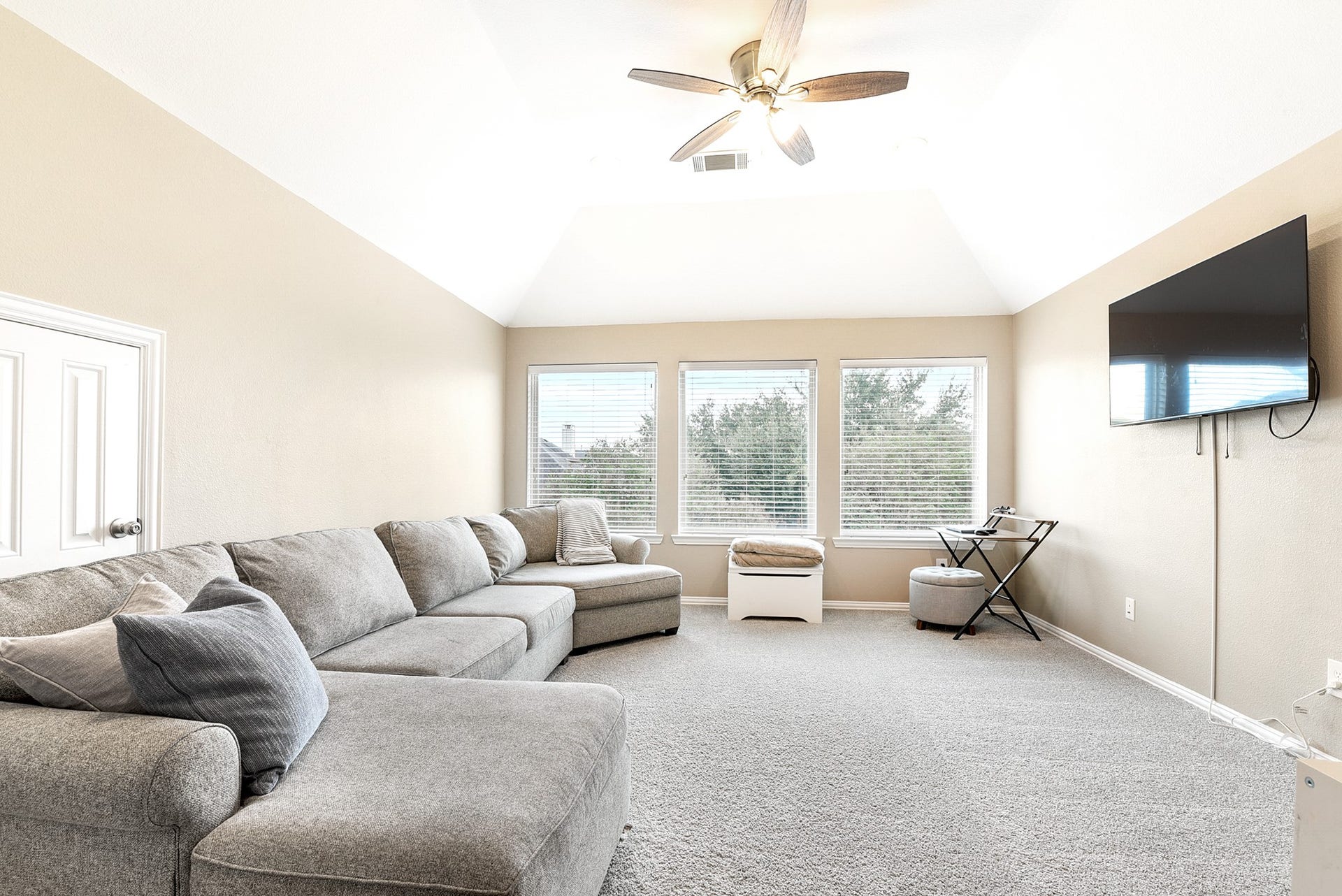 French doors open into a massive game room or media room, offering another versatile space. This room is large enough to serve a dual purpose, making it perfect for multiple uses.