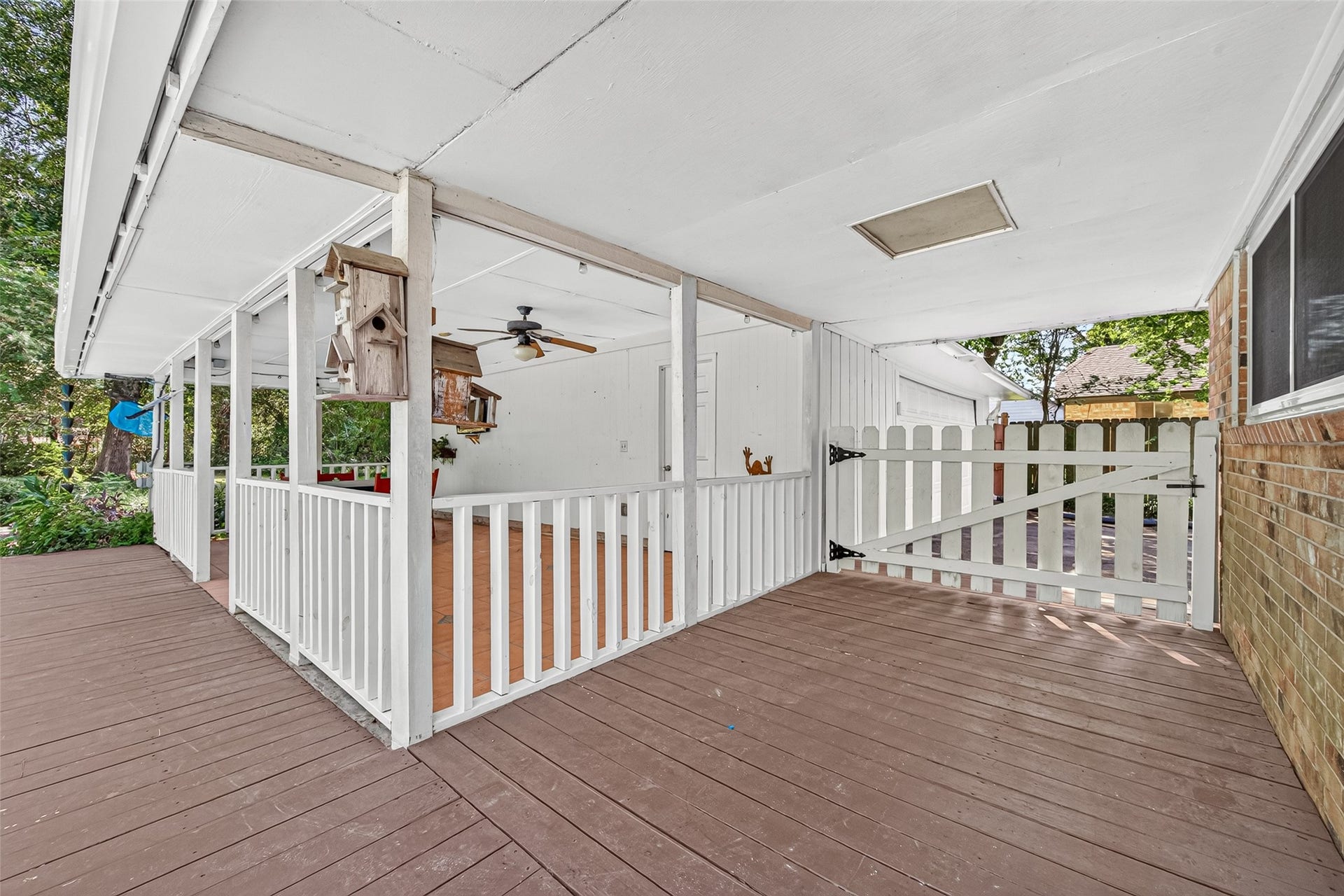 16814 Creeksouth Road, Houston, TX 77068 Covered deck patio with wrap around picket fencing and extra large swing gate.