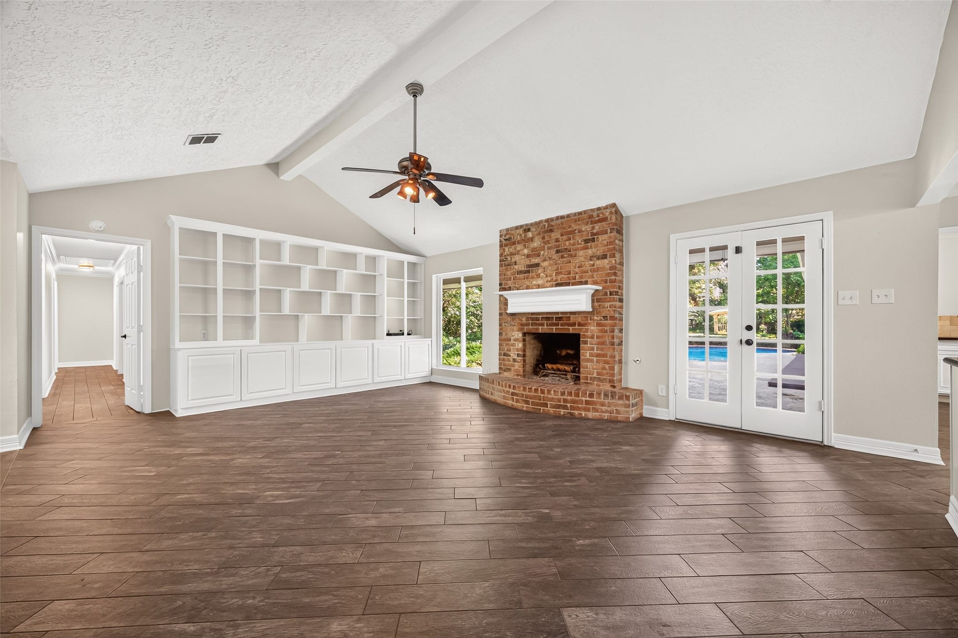 16814 Creeksouth Road, Houston, TX 77068 This spacious family room has so much to offer, a vaulted ceiling, deluxe built-in cabinetry and shelving, French doors opening up to the backyard oasis, and a large picture window to bathe the room in natural light.