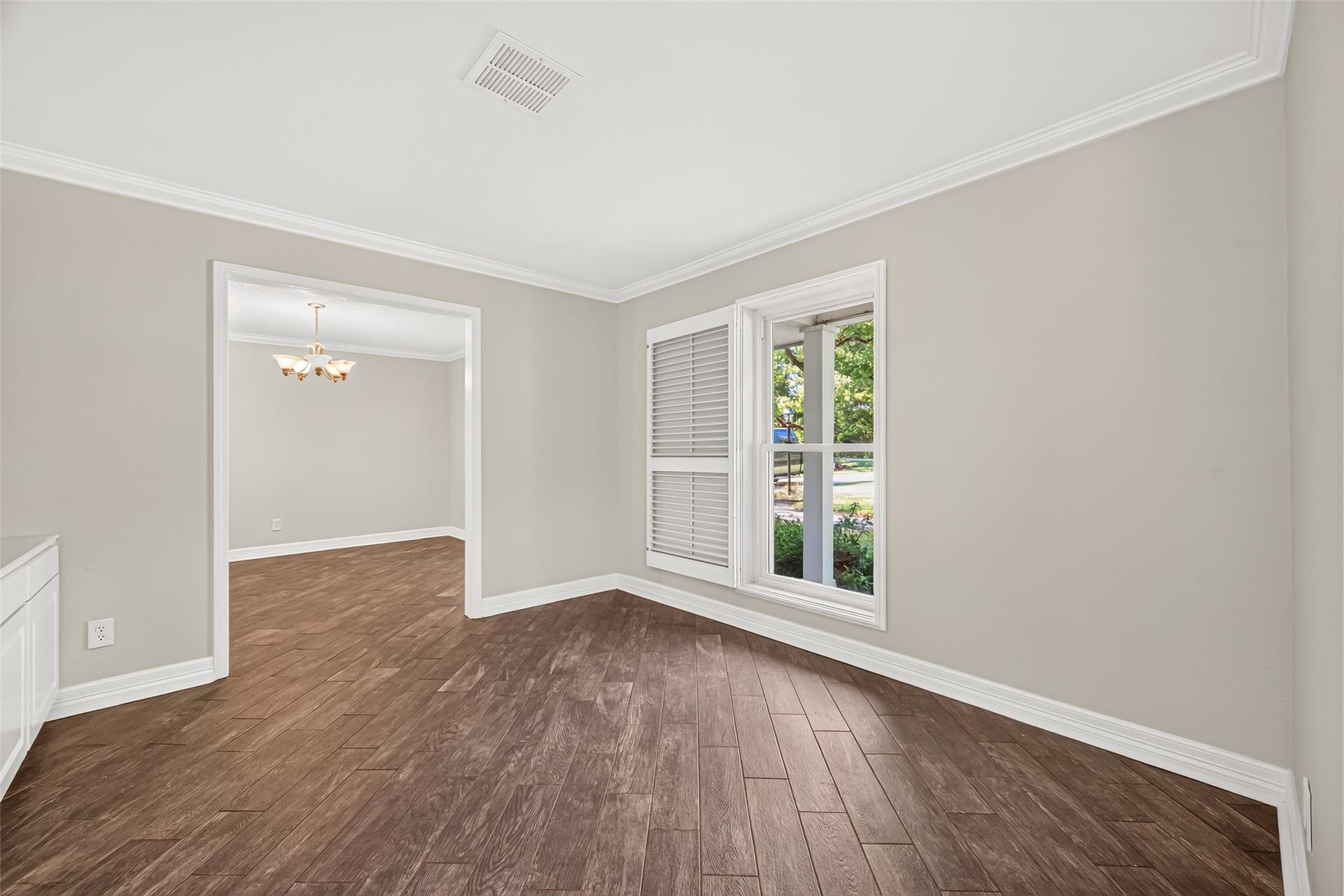 16814 Creeksouth Road, Houston, TX 77068 This is the study/library. The large window here is pictured with the custom shutter opened to allow the room to be lit up with natural light. Just beyond the door frame is the formal dining room.