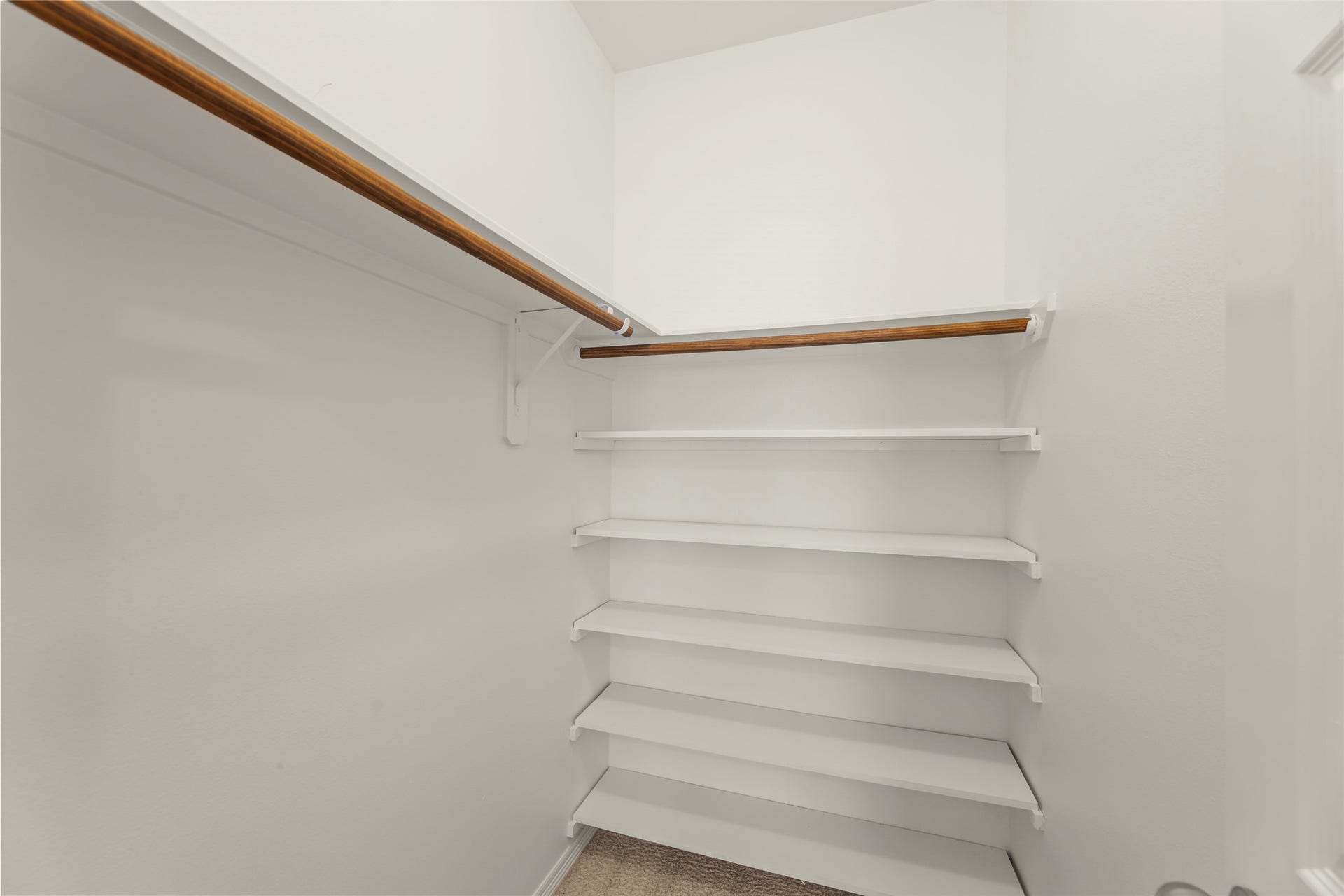 4534 Montcliff Bend Lane, Sugar Land, TX 77479 Spacious walk-in closet featuring ample hanging space and built-in shelving for organized storage.