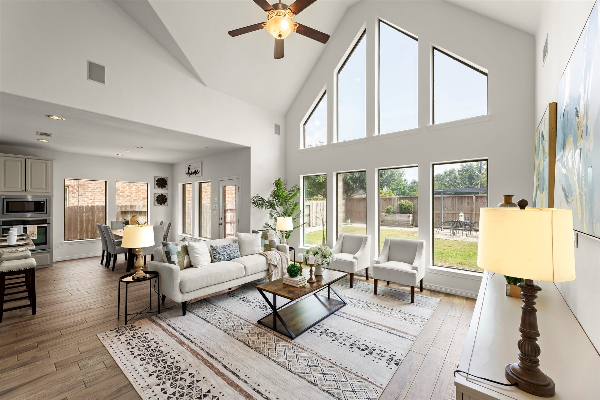 4534 Montcliff Bend Lane, Sugar Land, TX 77479 High ceilings and expansive windows offering abundant natural light, seamlessly connected to an elegant dining area and modern kitchen.