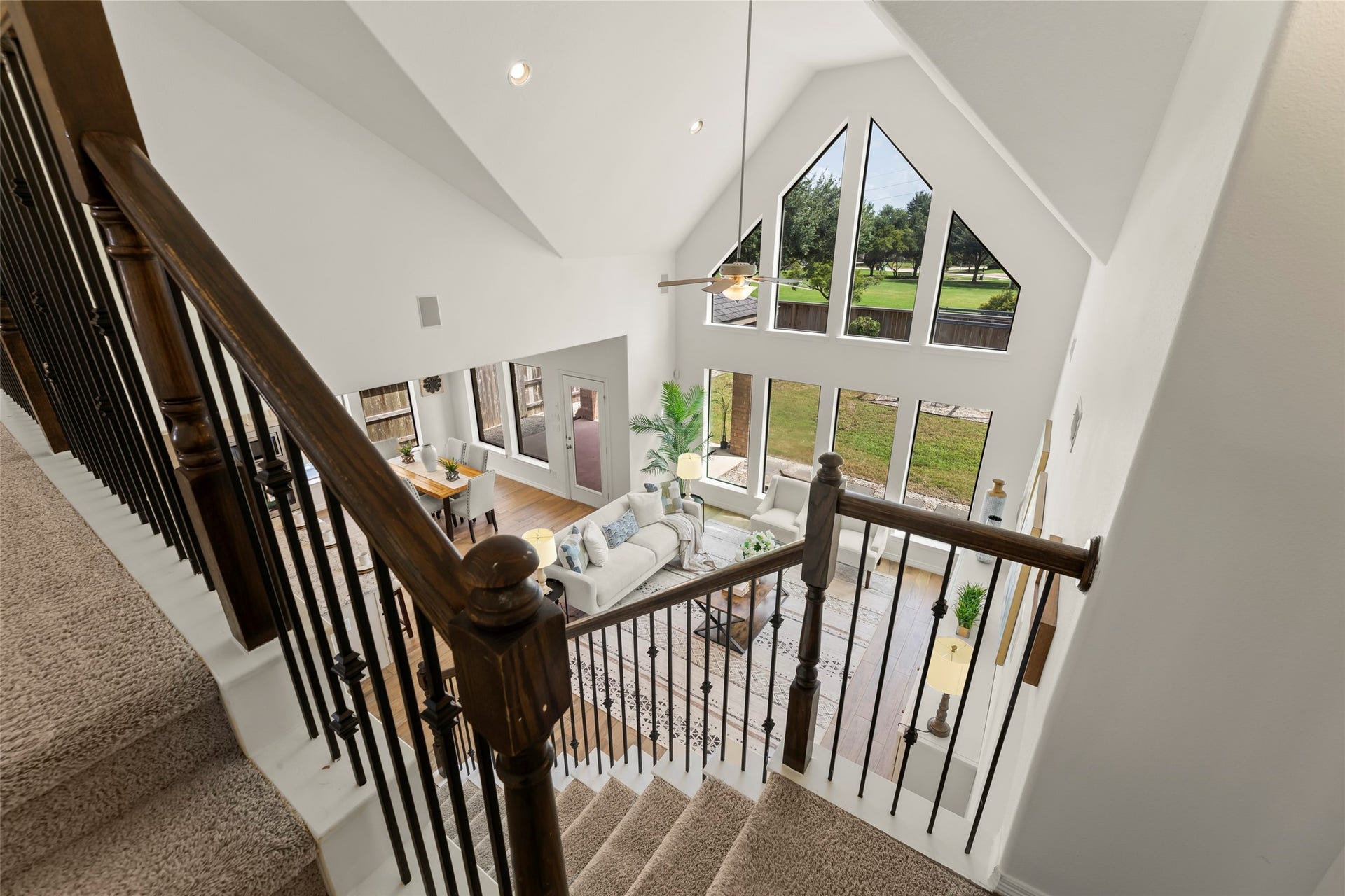 4534 Montcliff Bend Lane, Sugar Land, TX 77479 Stunning open-concept living area with soaring vaulted ceilings and expansive windows offering abundant natural light and picturesque views.