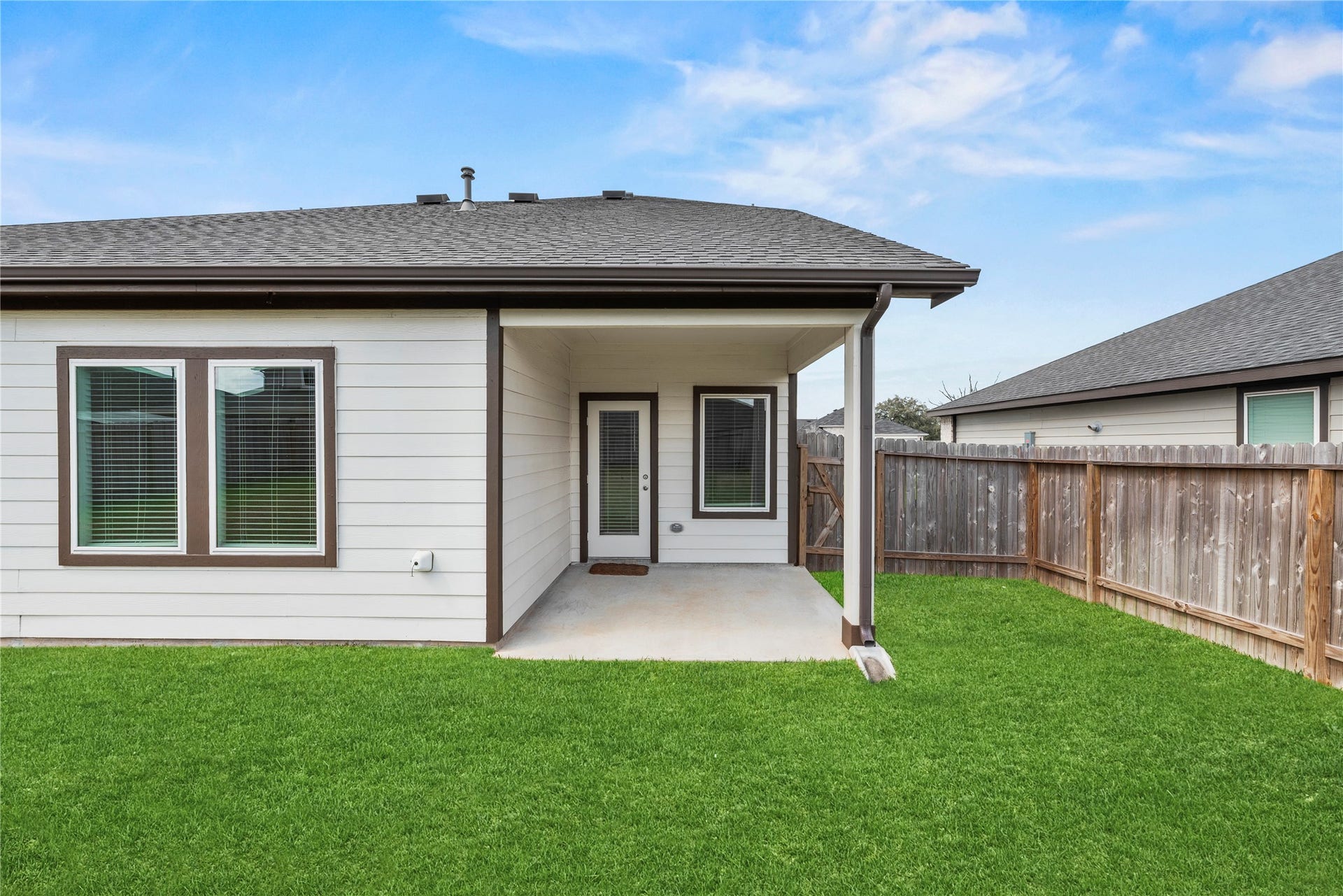Enjoy outdoor dining on the covered patio, which overlooks the lush grounds.