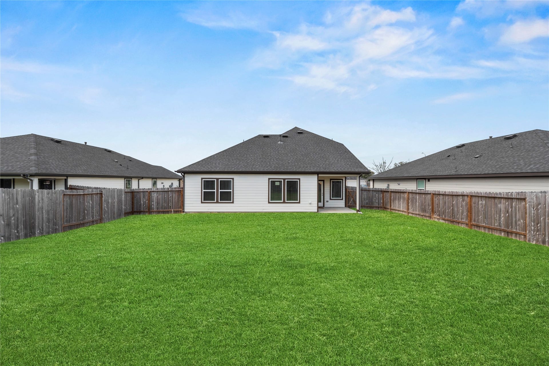 Step out and discover the inviting backyard, offering a wonderful green space for outdoor activities and relaxation.