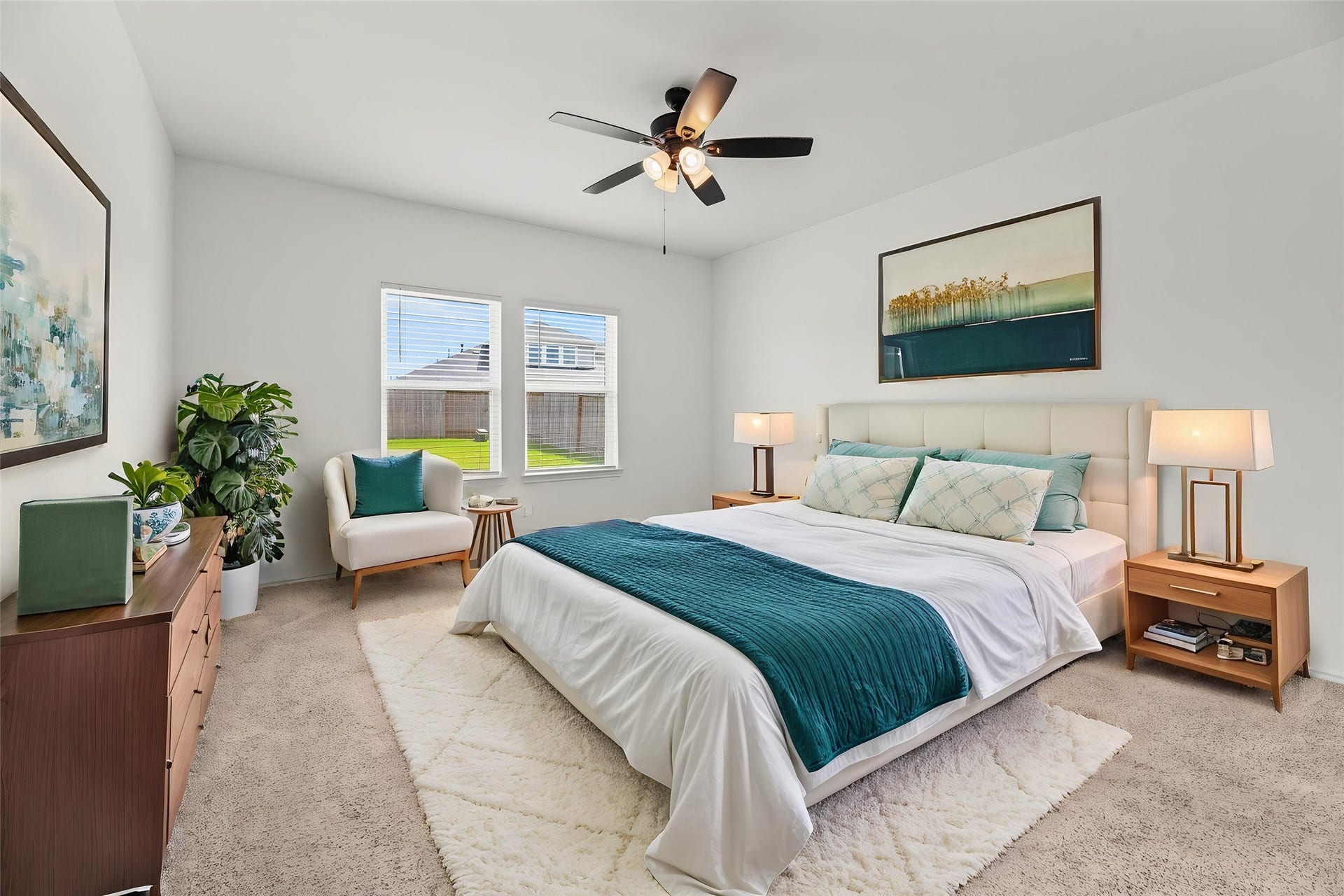 Located on the first floor, the spacious primary suite offers a peaceful sanctuary featuring high ceiling with a fan and large windows. This room provides direct access to the private en-suite bathroom for ultimate convenience. Virtually staged.