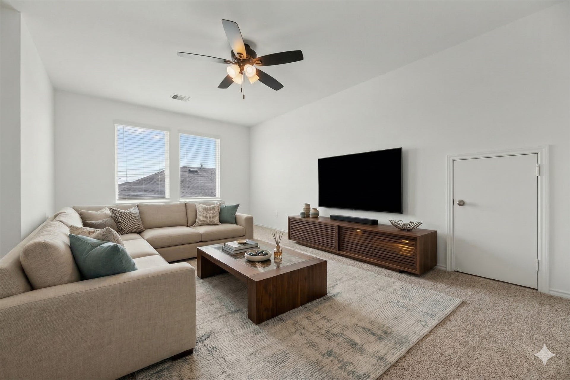 Located on the second floor, the generous gameroom offers a versatile secondary living area perfect for recreation or a media hub. The space features large windows and a modern ceiling fan.  Virtually staged so you can imagine the possibilities.